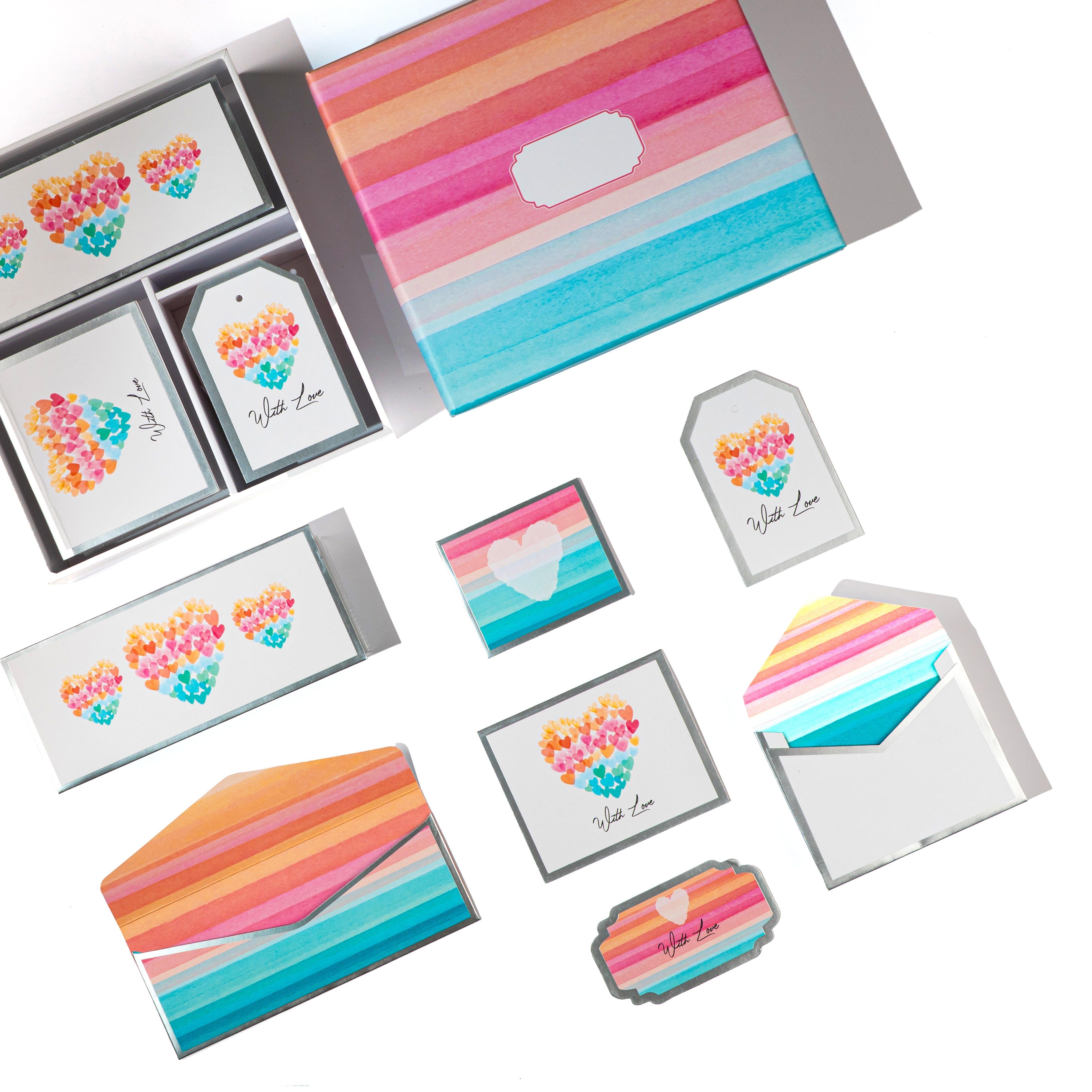 Pastel watercolor stationery set with striped envelopes, folded cards, gift tags, and sticker tags arranged in a coordinated gift box.