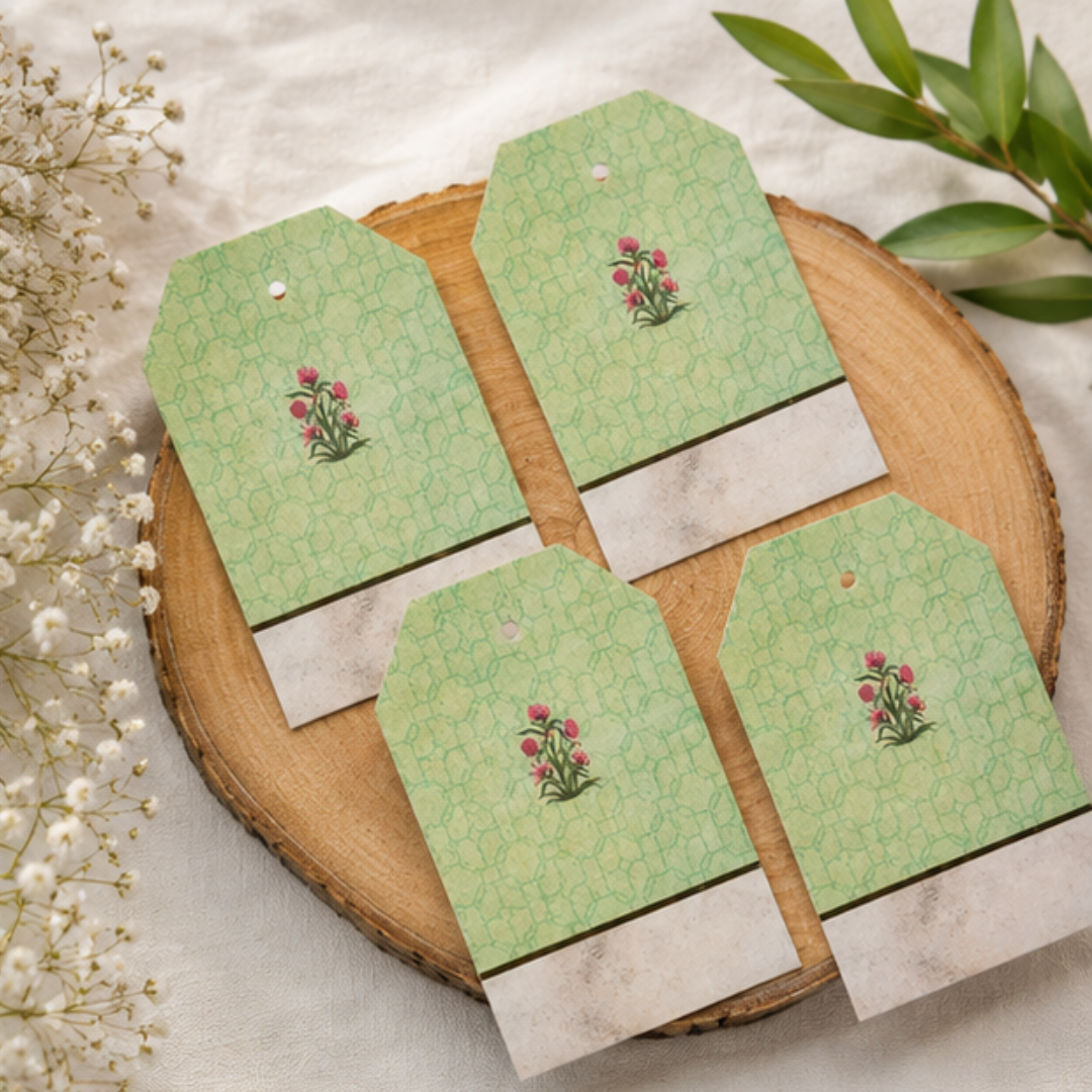 Luxury floral hanging tags displayed with gift boxes and golden ribbons, perfect for weddings, hampers, and festive packaging.