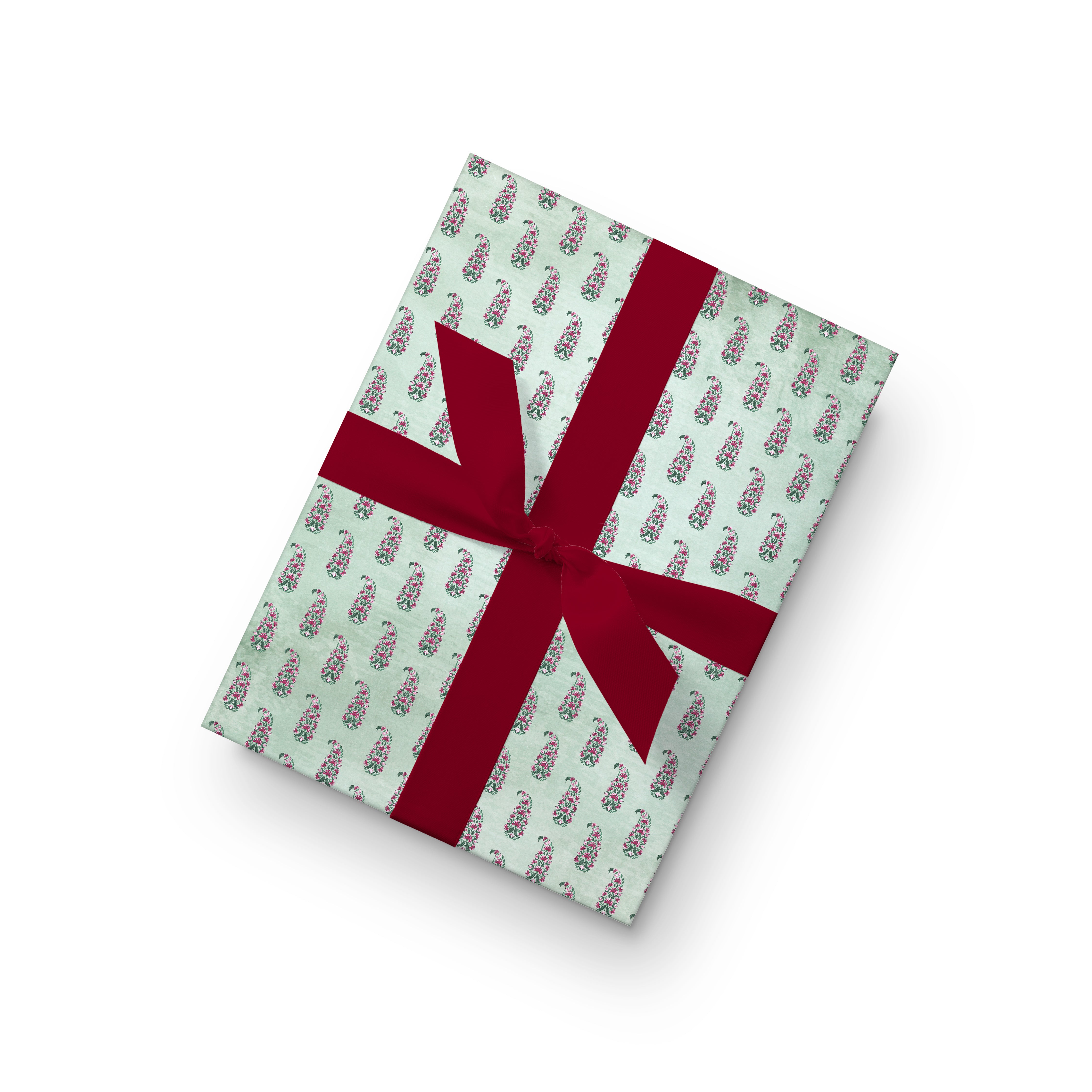 Wrapping paper with repeated pink floral paisley motifs on a soft mint green textured background.