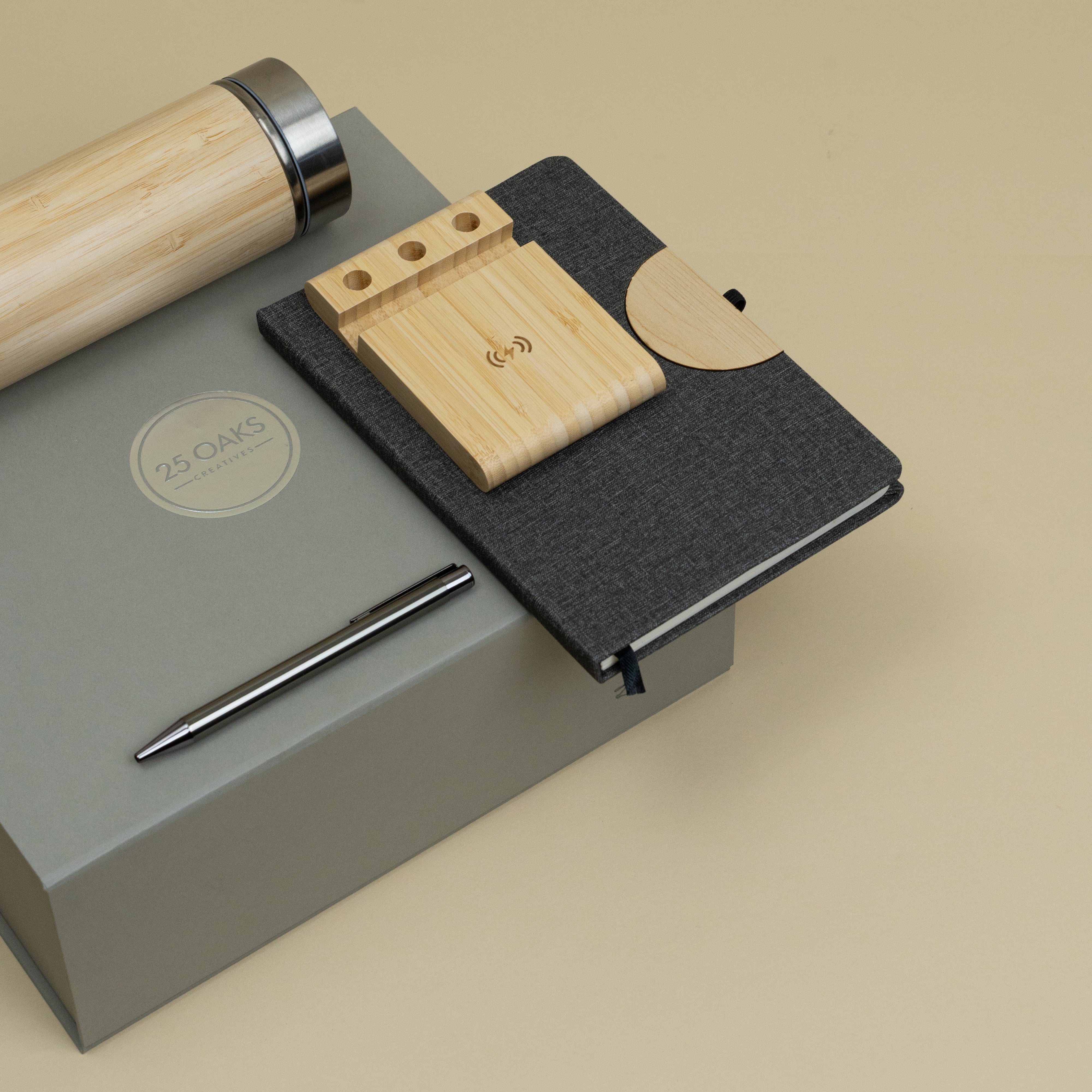 The Hybrid Desk corporate gifting set with bamboo bottle, diary, metallic pen and wireless charging stand presented in a premium gift box.