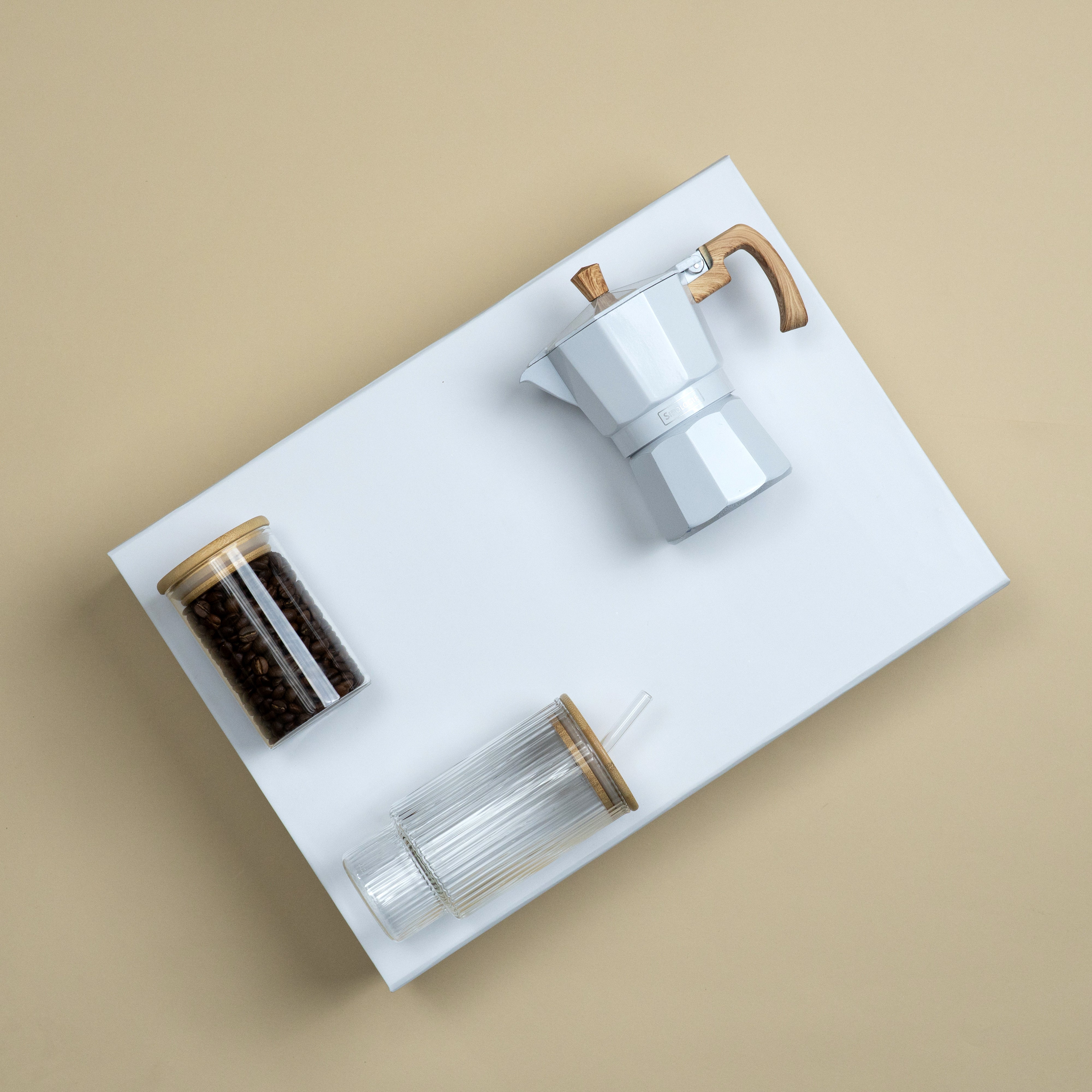Premium corporate coffee gifting set featuring a white moka pot, glass coffee jar and coffee bean storage jar without edibles.