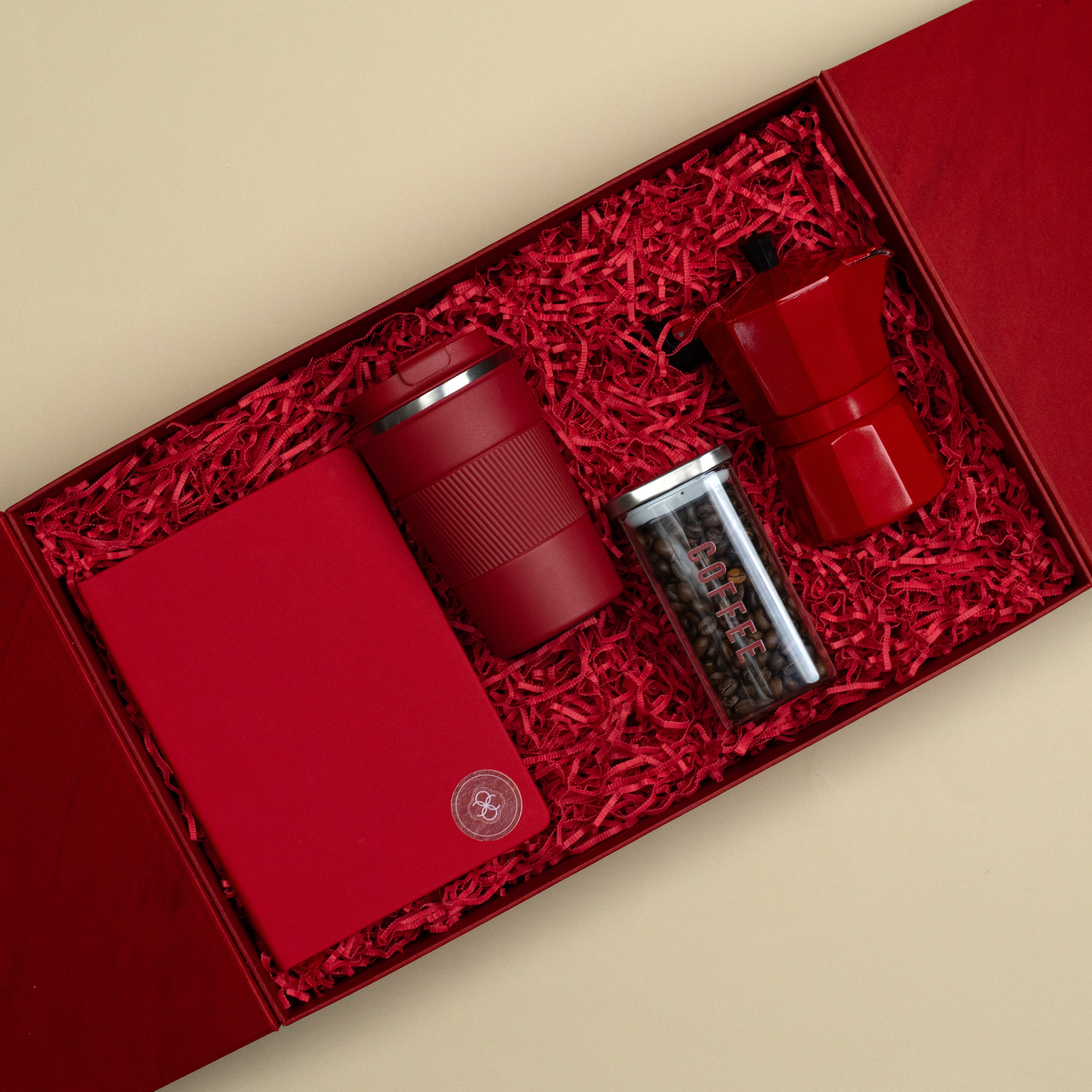 Red corporate coffee gift set with notebook, vacuum mug, moka pot and glass coffee jar.