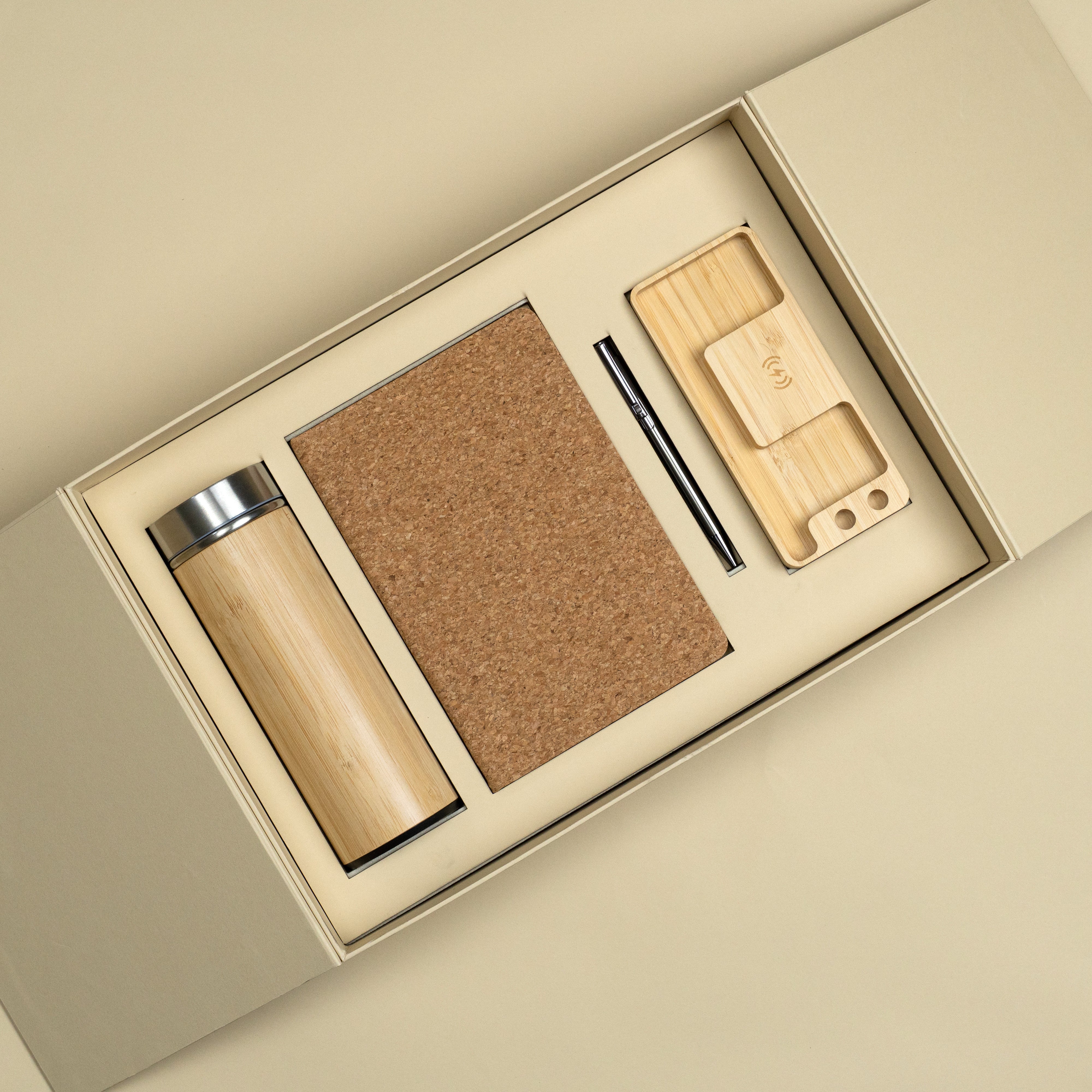 Eco-friendly corporate gift set with bamboo bottle, cork diary, pen and wireless charger.