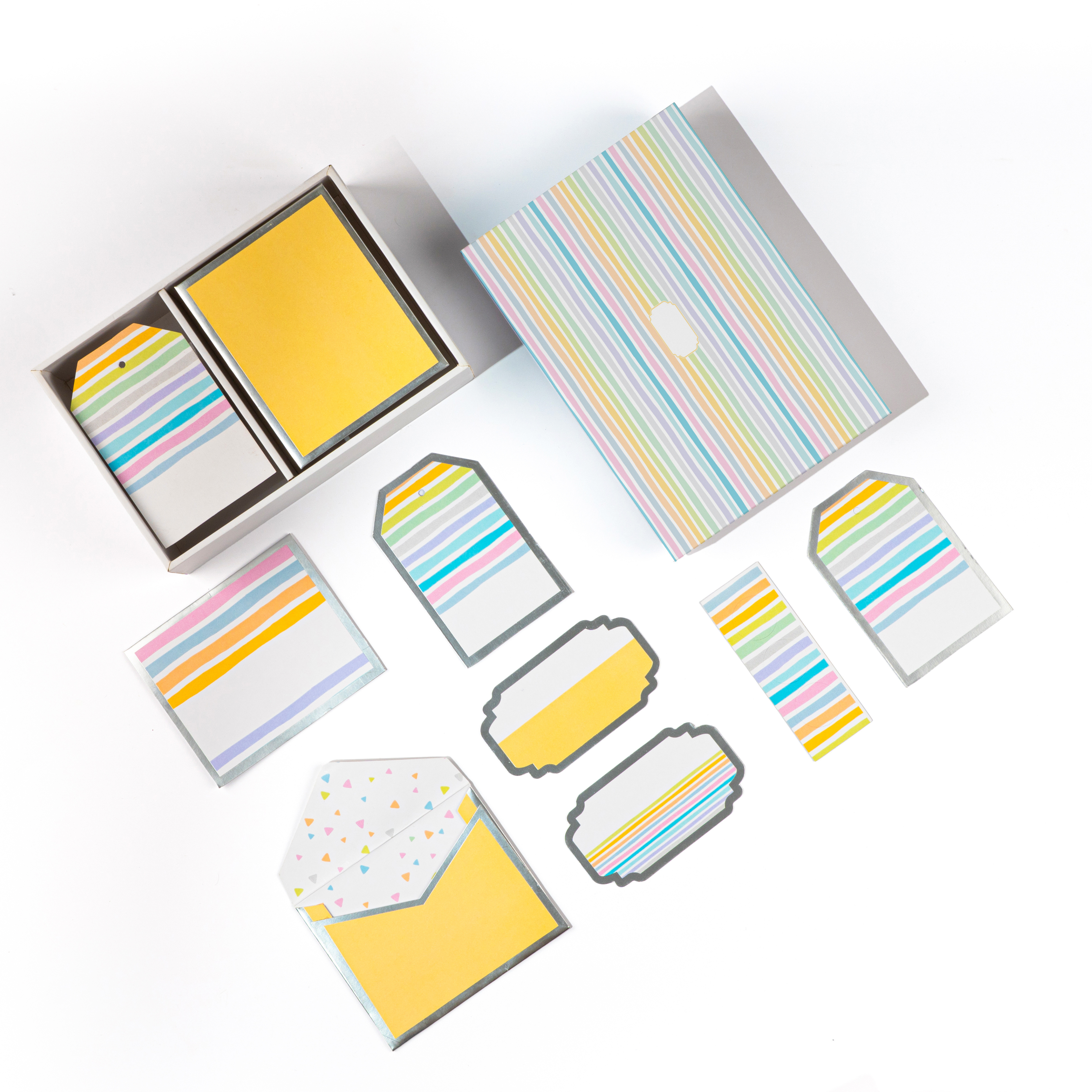Colorful striped stationery set with gift tags and small folded envelopes.
