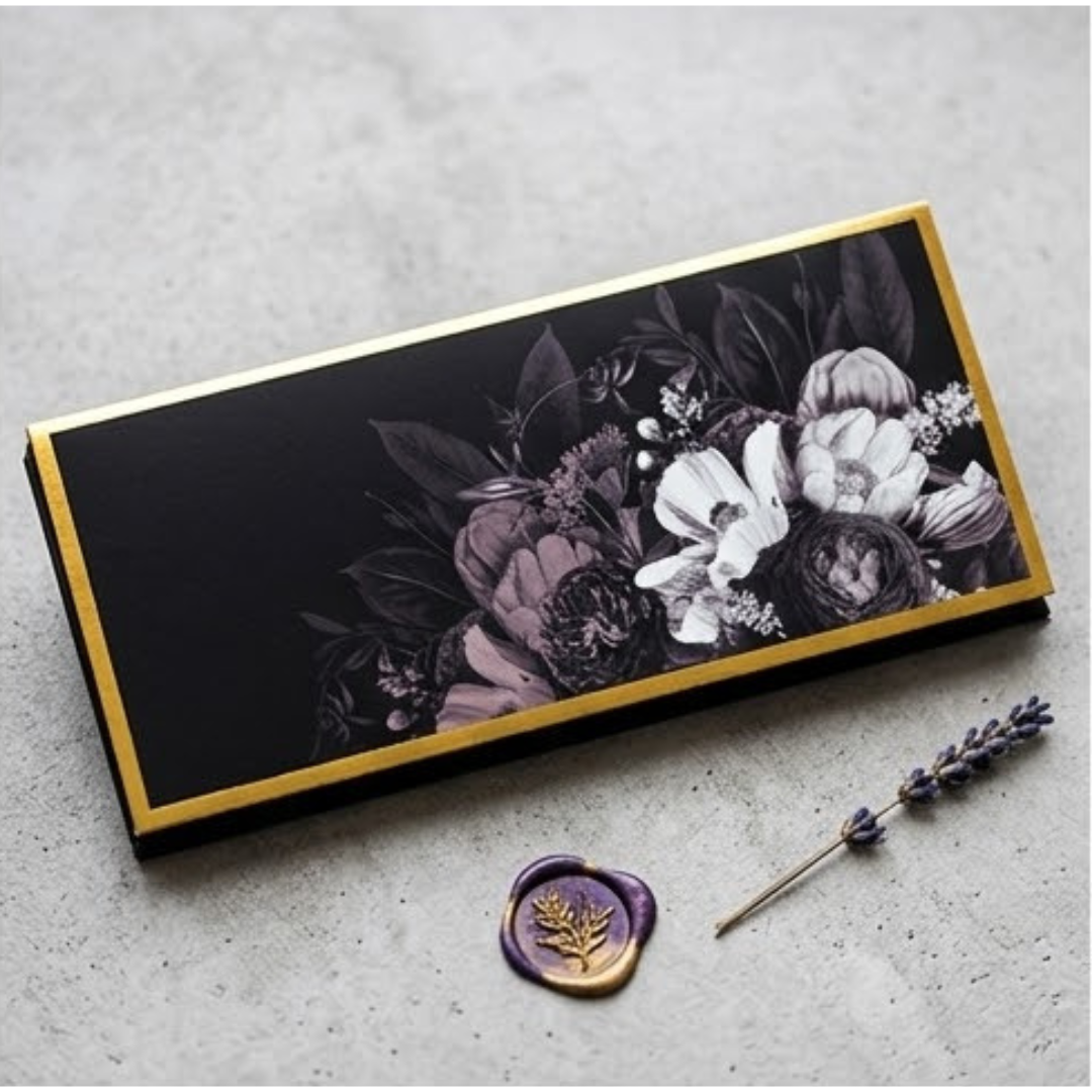 A sophisticated set of money envelopes in black, adorned with white and grey blooms and elegant gold details.