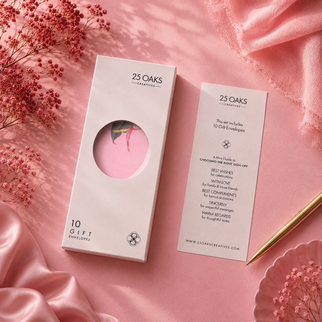 Sophisticated designer envelope in blush pink tones with gold edging and vibrant botanical accents in a premium flat-lay setup.