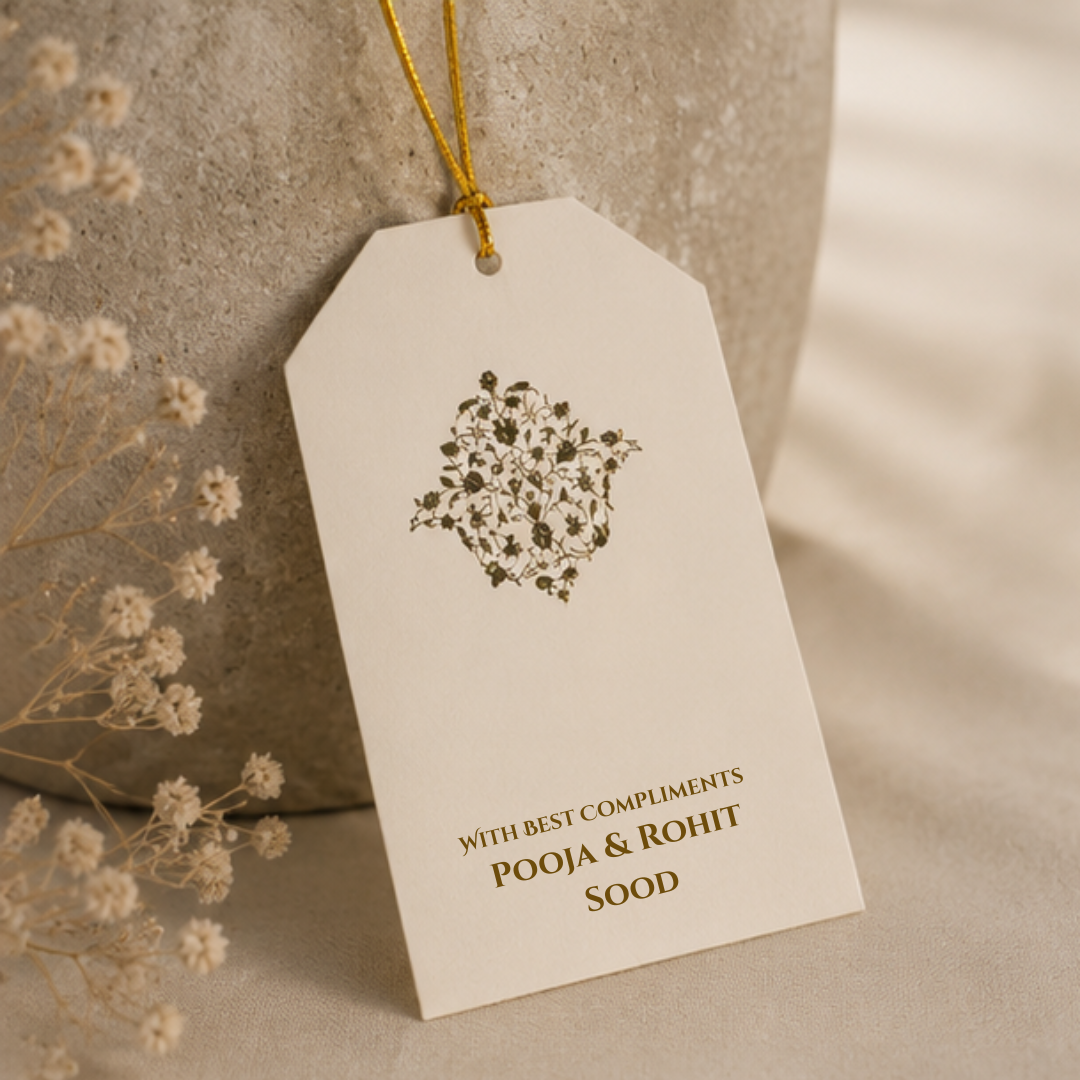 Minimal floral hanging tag with delicate botanical artwork and golden dori, styled in an elegant neutral-toned product photoshoot.