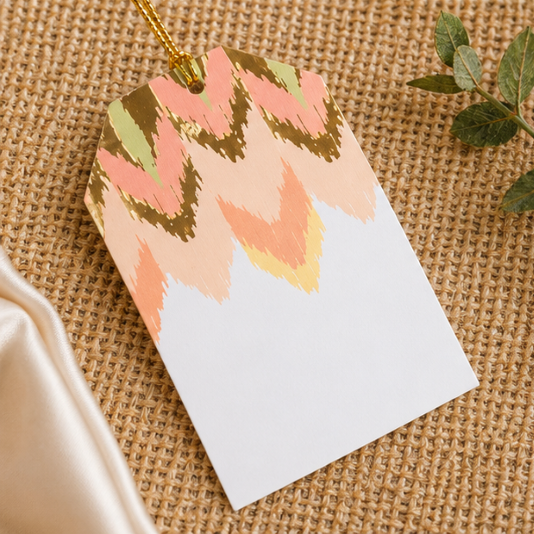 Modern abstract hanging gift tags with soft pastel tones and gold accents, beautifully arranged in an elegant flat lay composition.