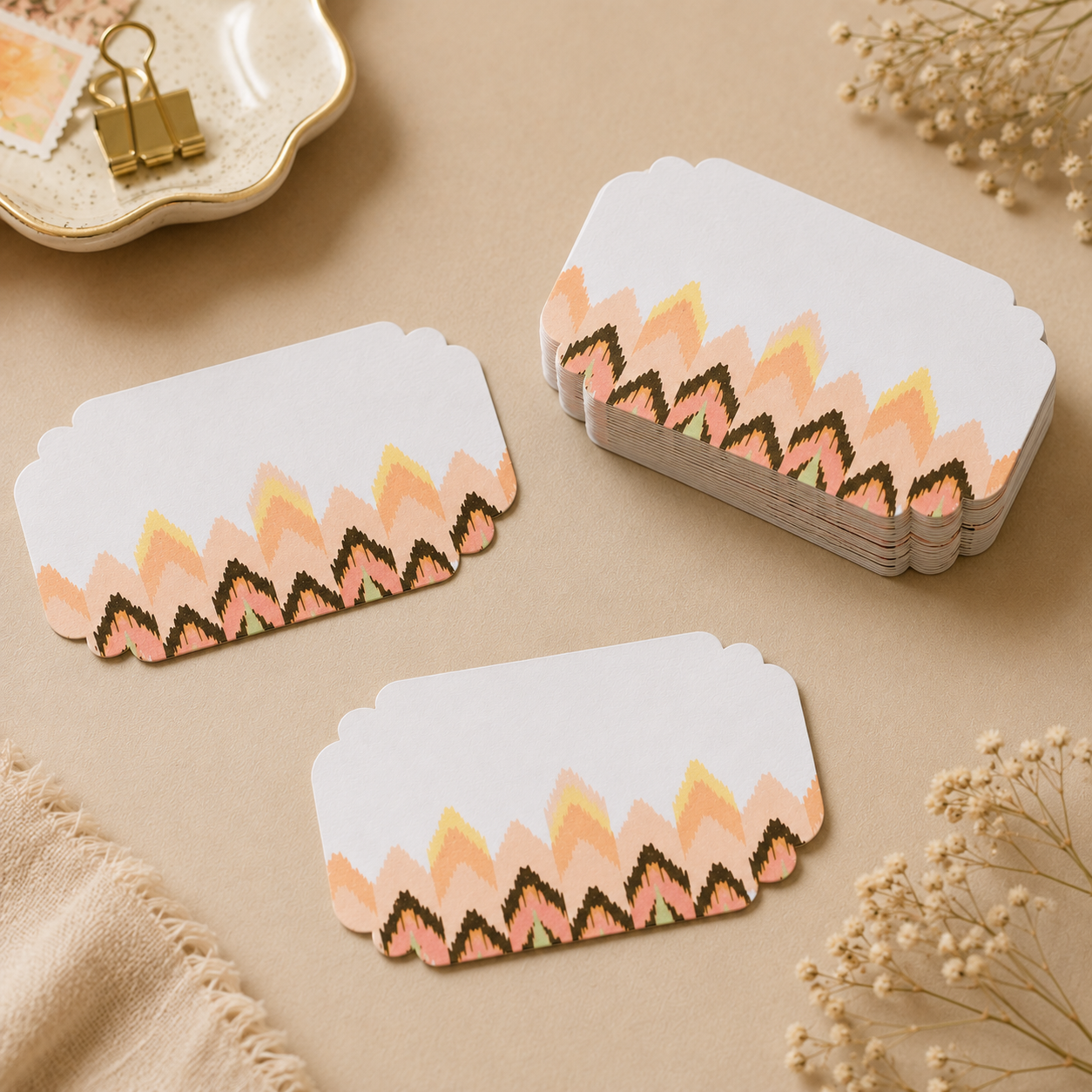 Elegant peel and stick gift tags with pastel ikat-inspired patterns, featuring two scattered stickers and a neatly stacked set on a soft beige background.