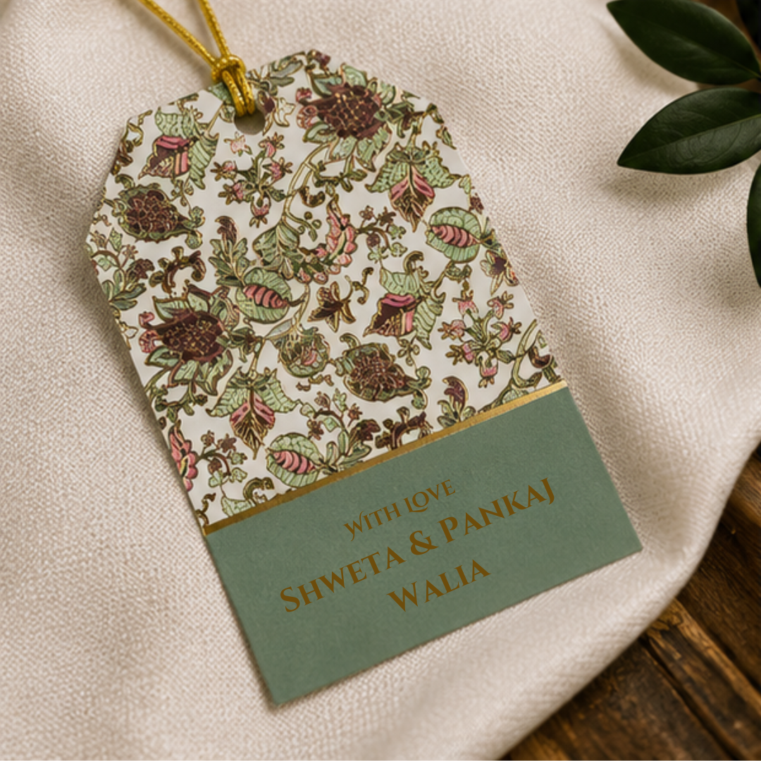 Elegant floral hanging gift tags with intricate botanical artwork, sage green detailing, and golden dori styled in a luxury photoshoot.