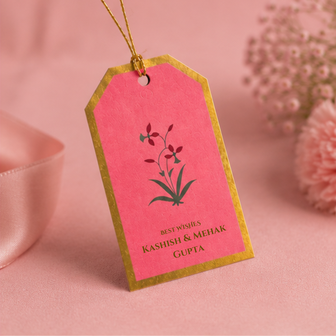 Elegant pink hanging gift tags with gold borders and delicate botanical artwork, styled in a soft pastel luxury photoshoot.