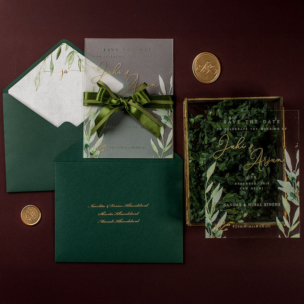 Transparent acrylic wedding invitation with green foliage print