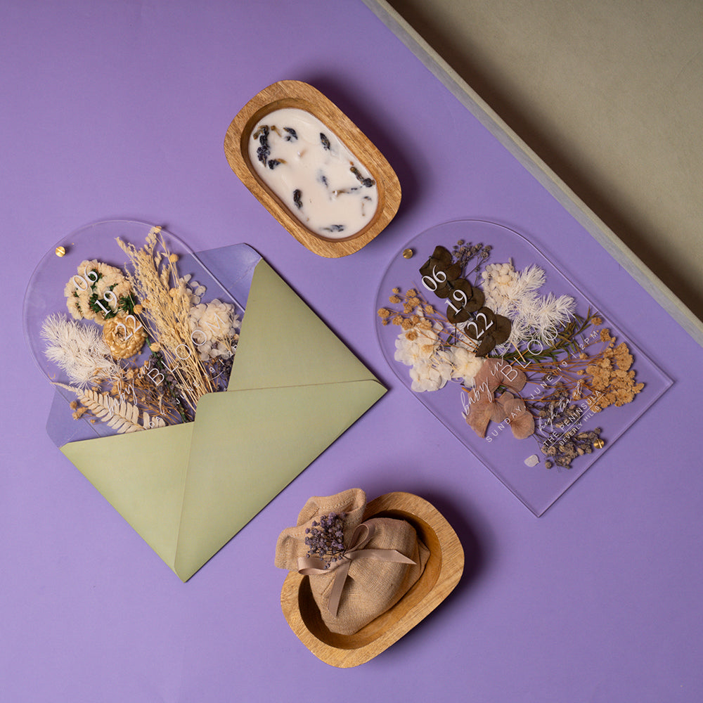 Beachside baby shower invite with preserved florals, acrylic card, candle and lavender sachet in pastel earthy tones