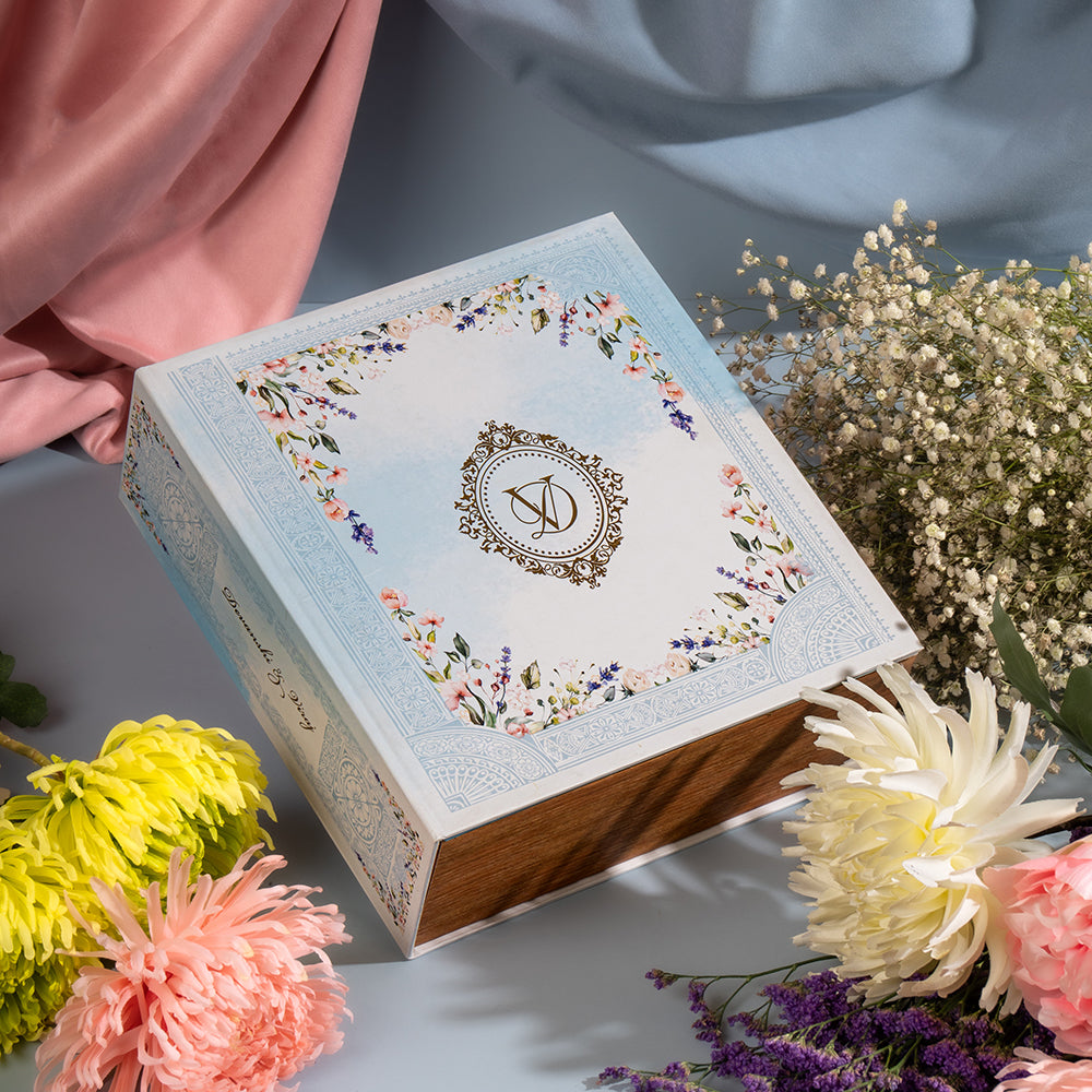 Floral wedding invitation book box with pastel design and decorative monogram