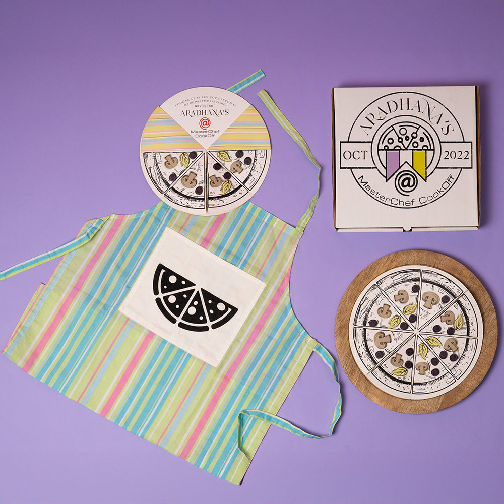 Pizza-themed birthday invite in custom pizza box with personalised aprons for a kids’ cooking party celebration