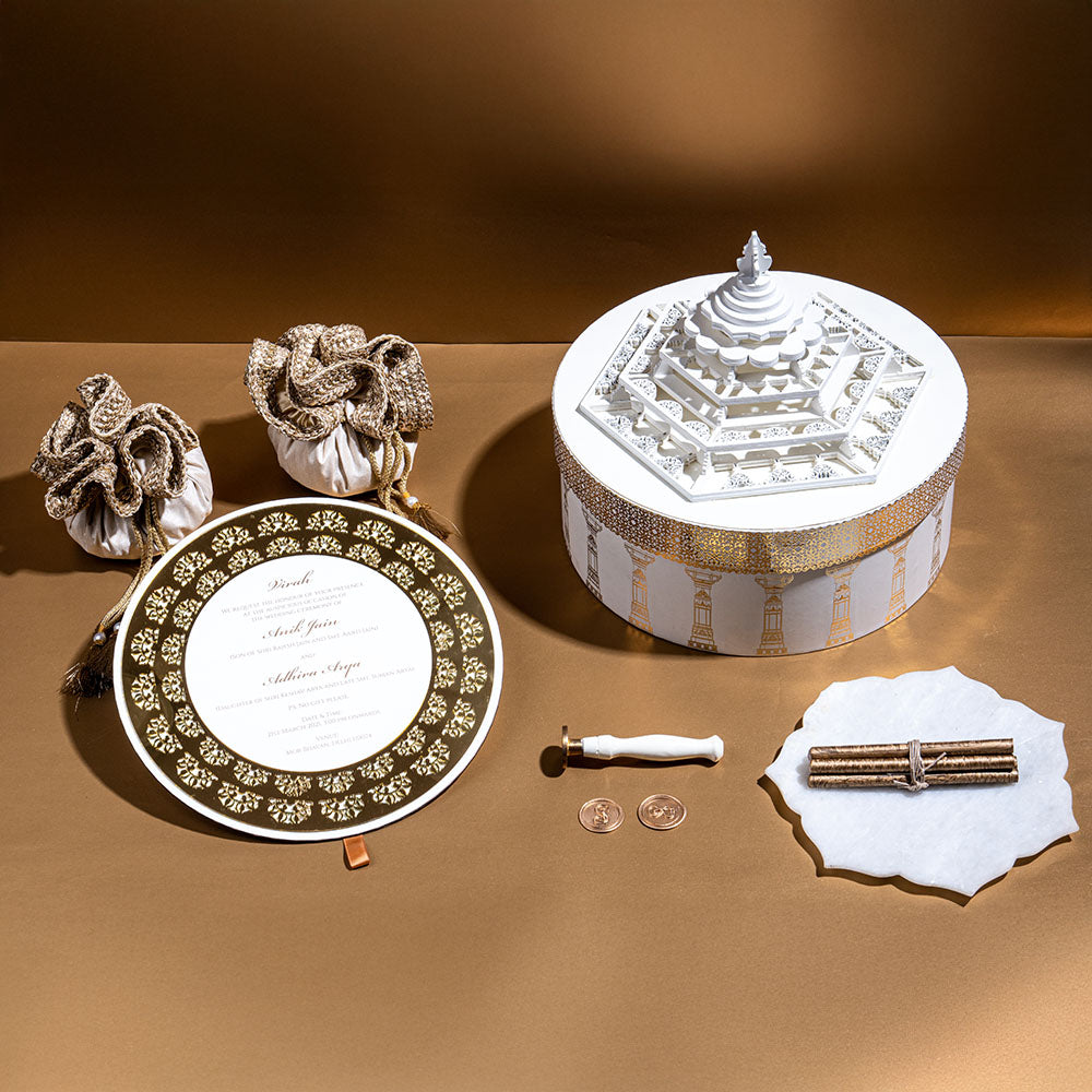 Architectural mandap-themed invitation box with sculptural layers and gold foil