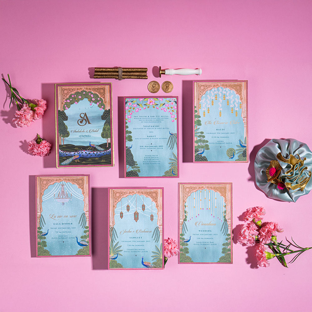 Luxury Jaipur wedding card with lotus, chandeliers, and mythic garden designs