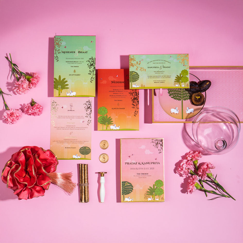 Indian wedding invitation in blush, orange, and green with traditional motifs