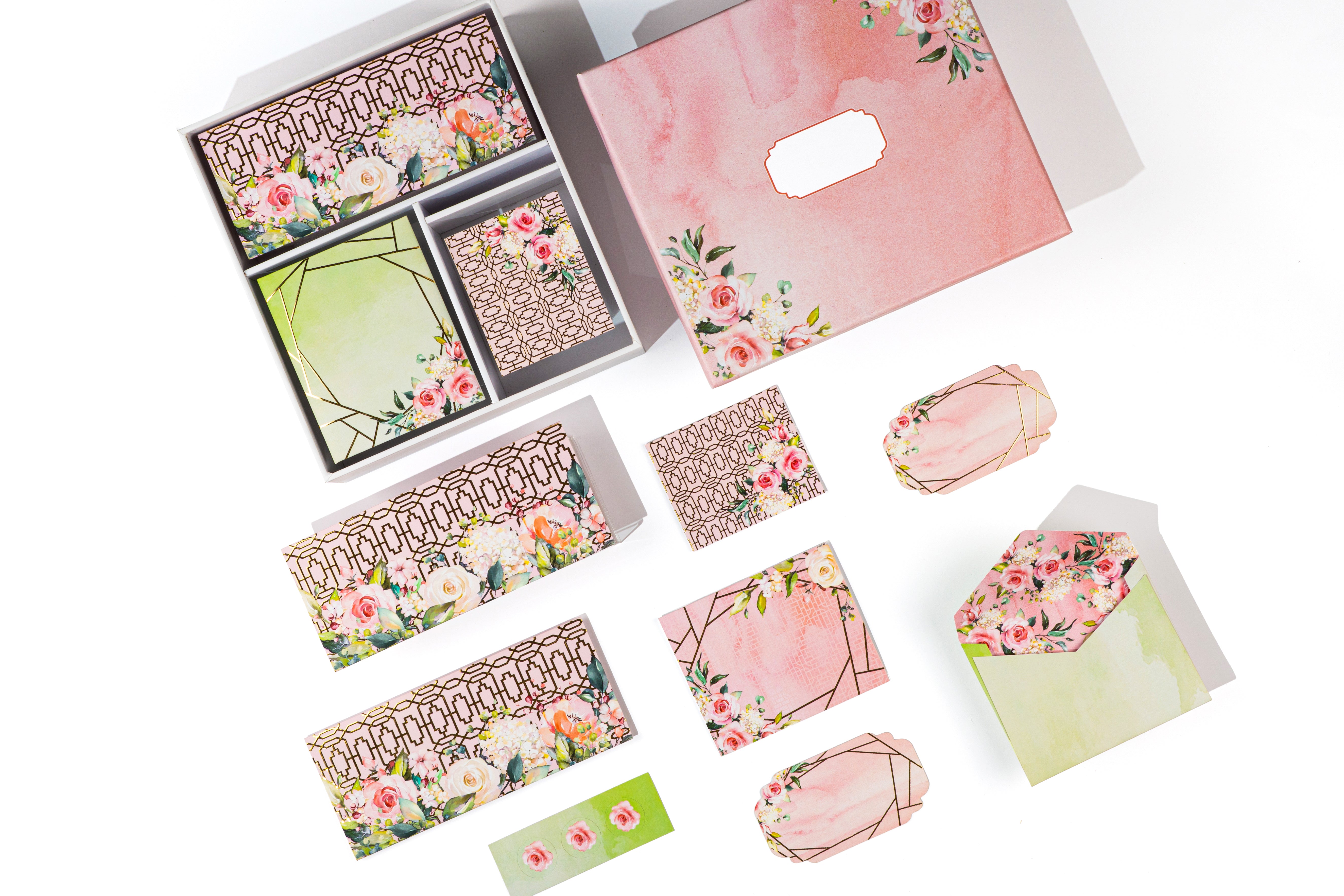 Luxury floral stationery gift set featuring blush pink and sage green tones with gold geometric accents, envelopes, cards, tags, and a keepsake box.