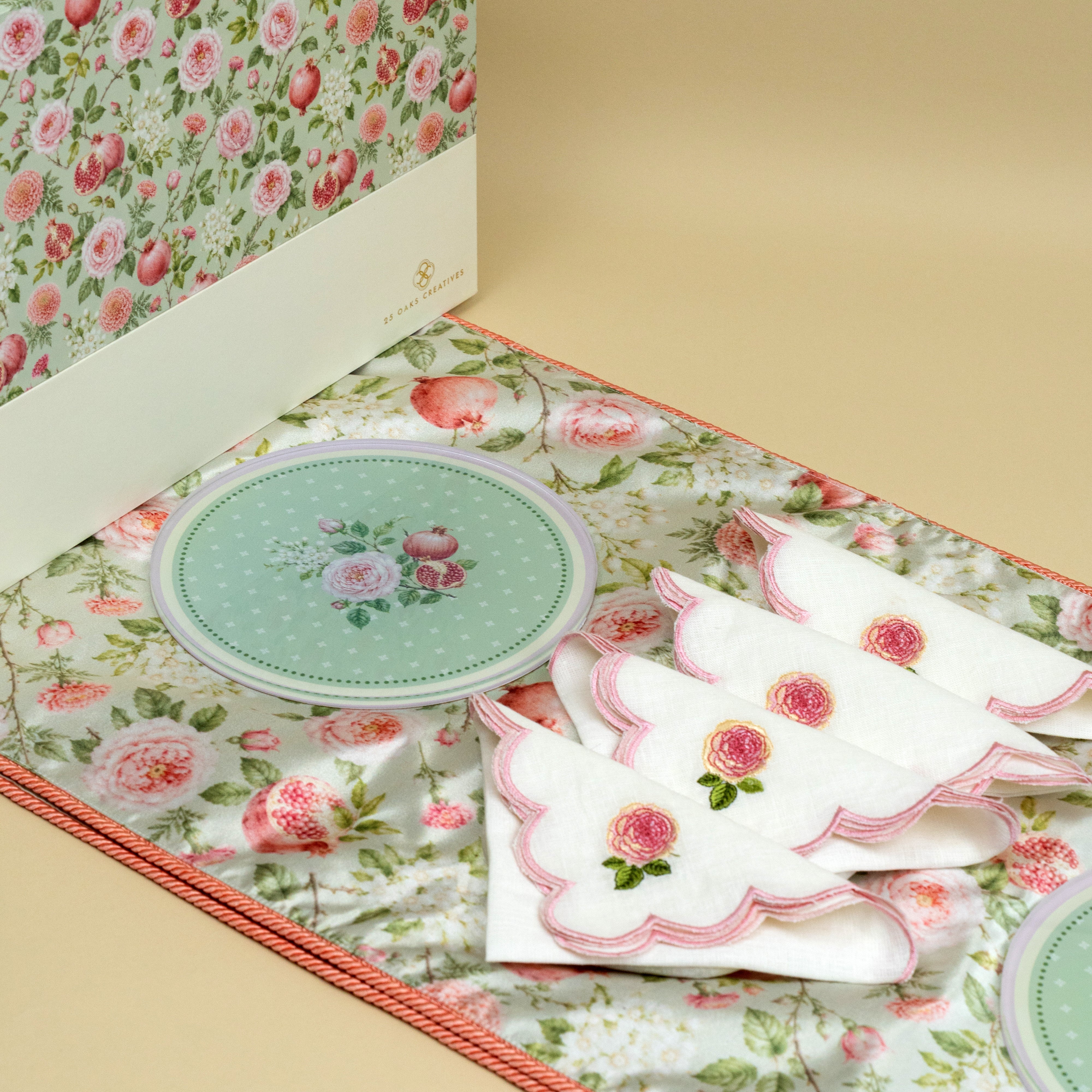 Floral table runner with four decorative trivets and embroidered dinner napkins