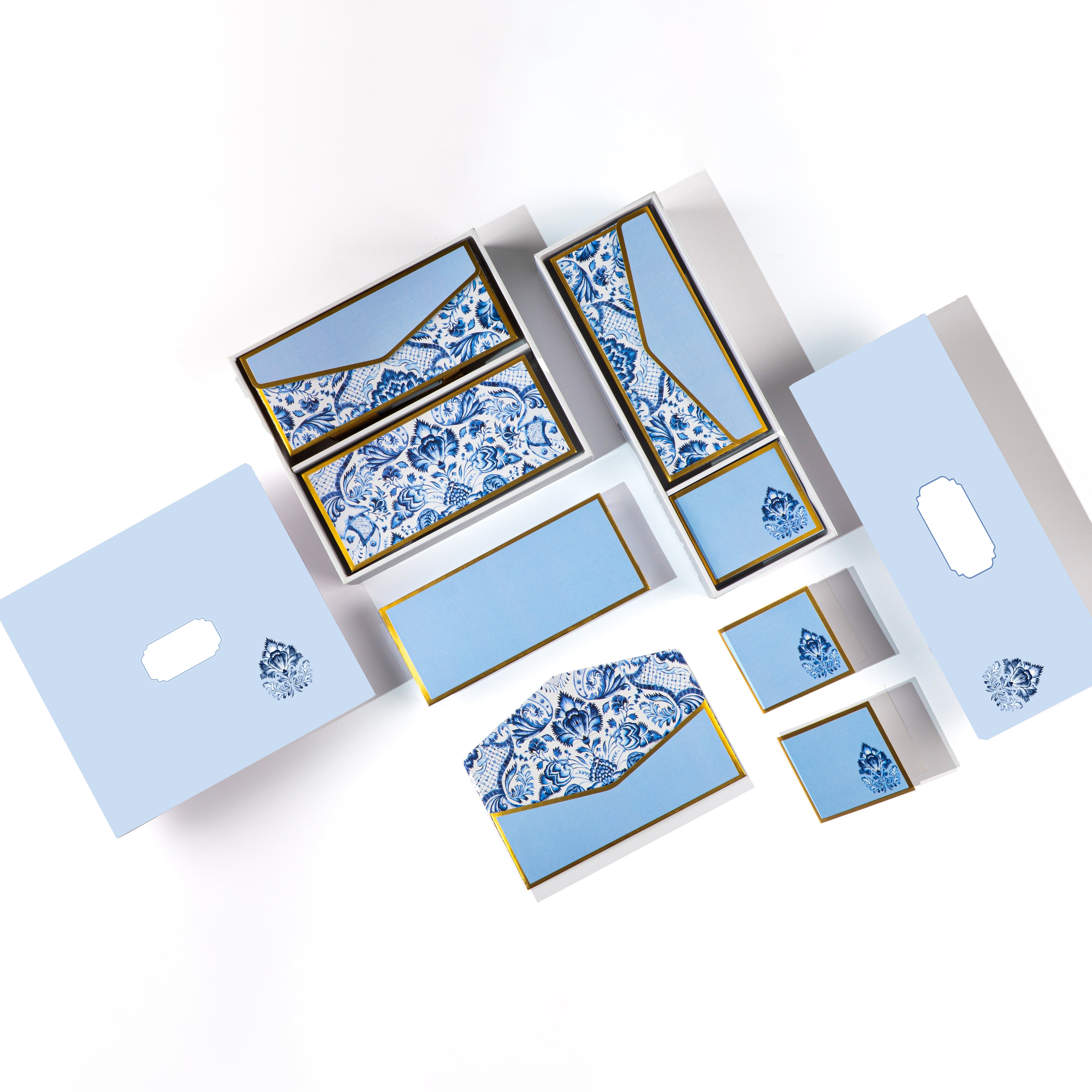 Blue and white Mughal floral stationery set with gold detailing, includes matching cards, tags, and envelopes.