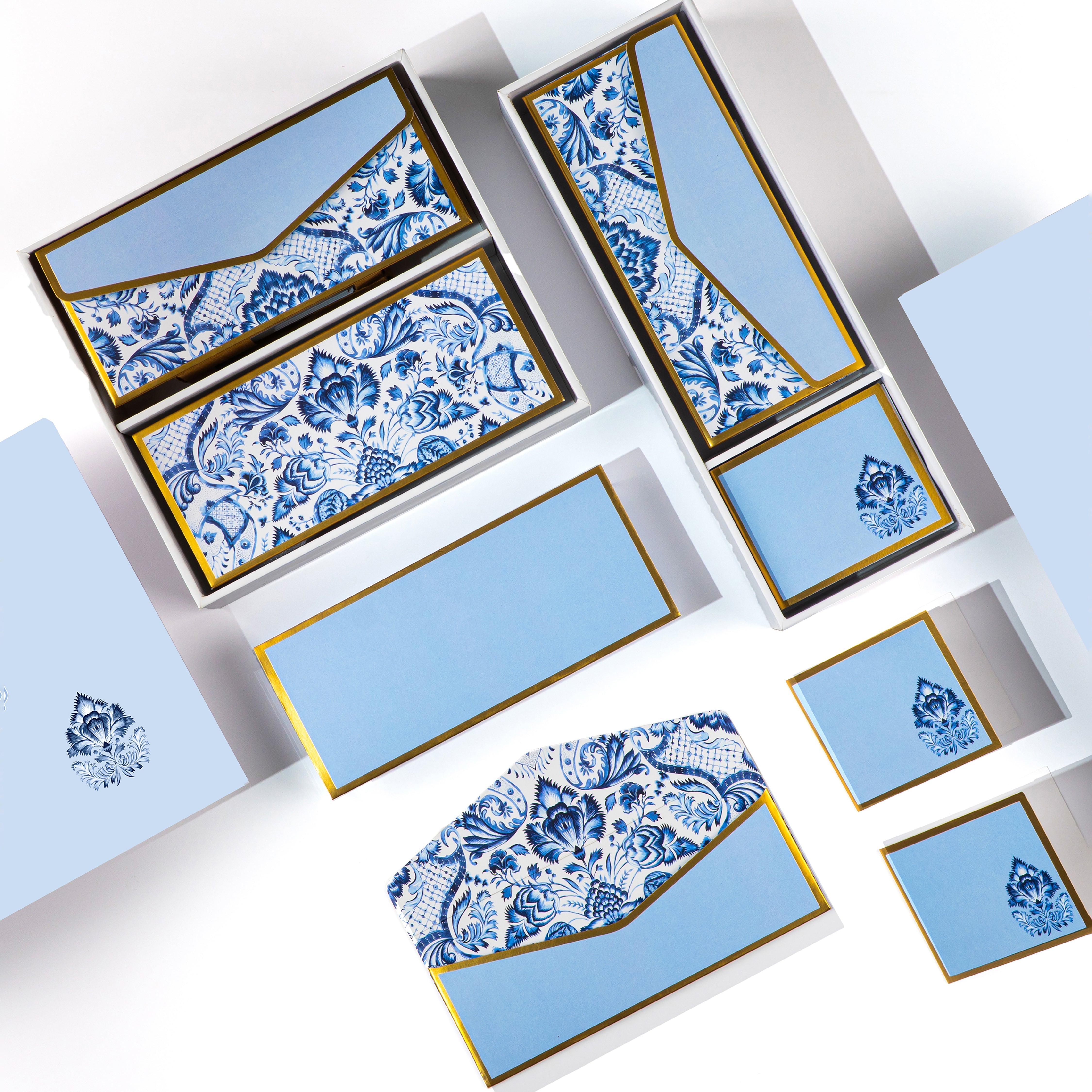 Blue and white Mughal floral stationery set with gold detailing, includes matching cards, tags, and envelopes.