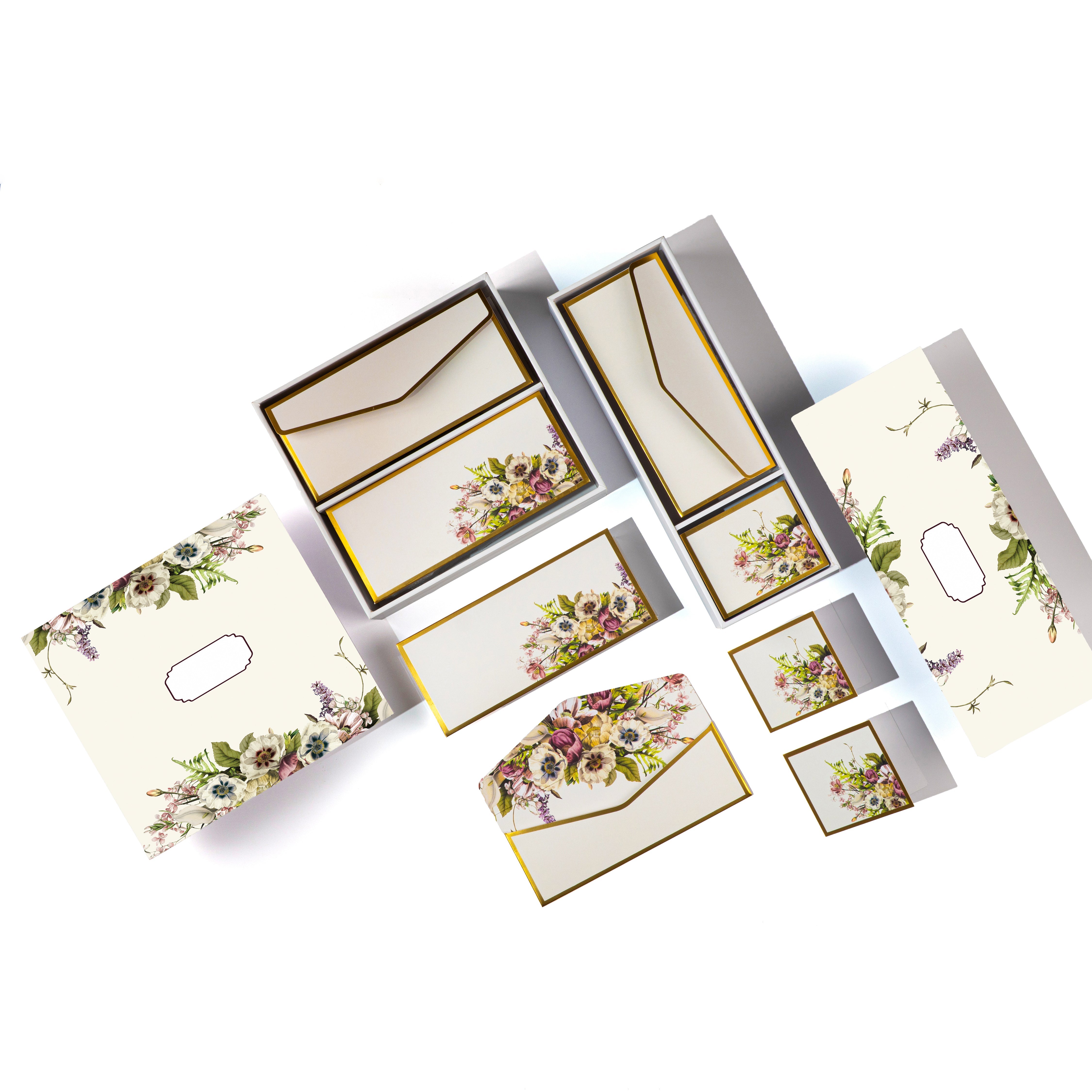 Cream boxed stationery with elegant floral bouquets on cards, tags, and envelopes.