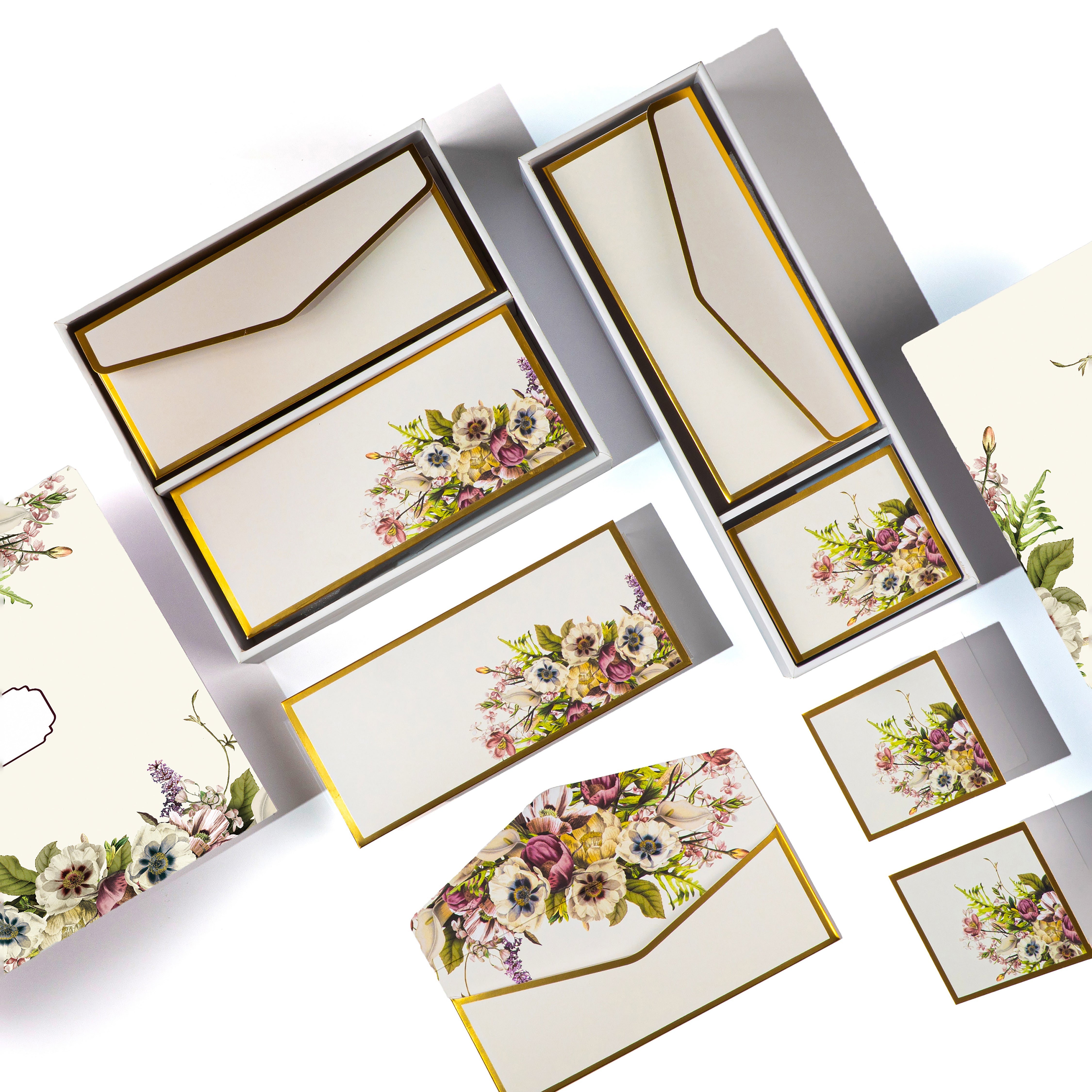 Cream boxed stationery with elegant floral bouquets on cards, tags, and envelopes.
