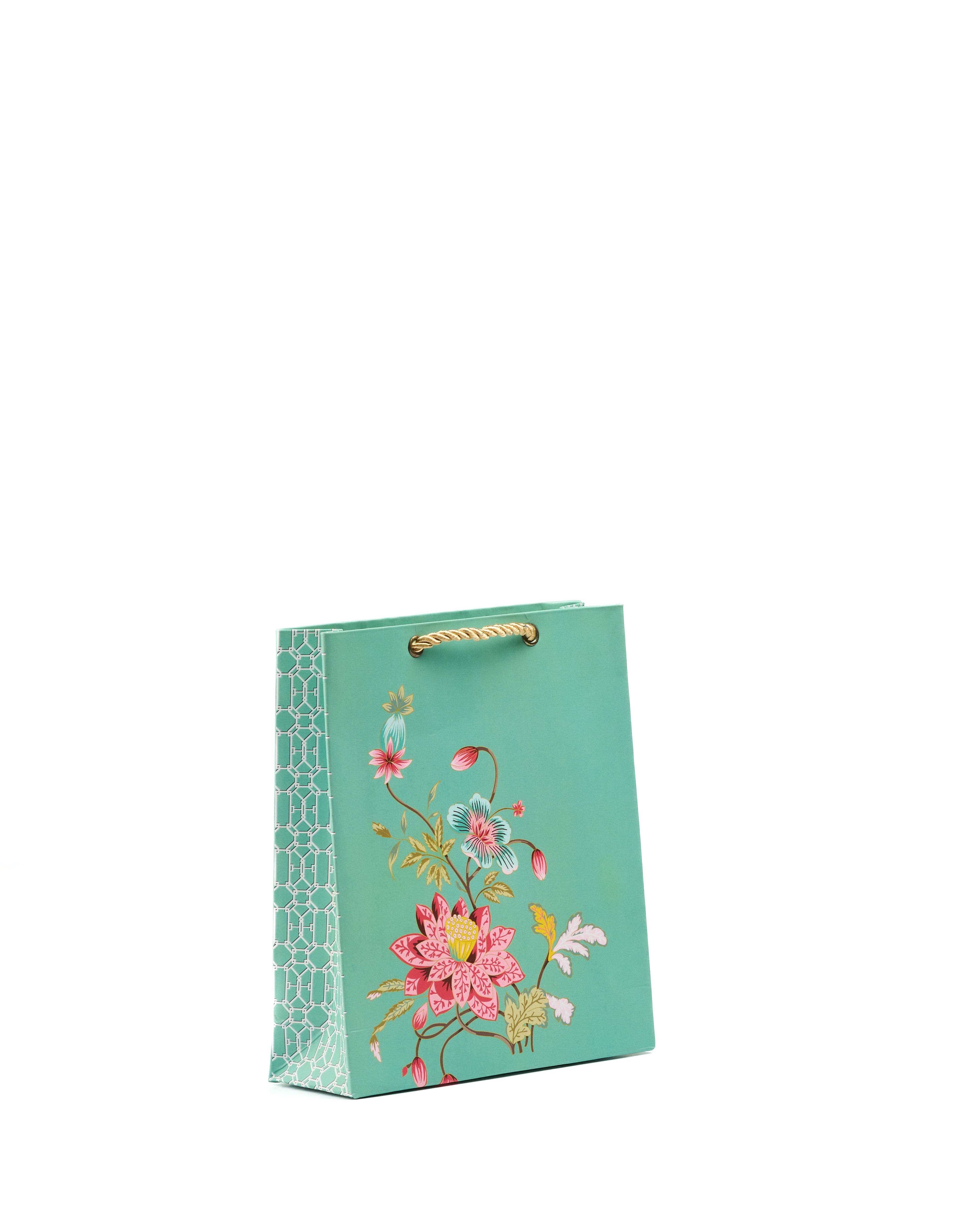 Green floral printed gift bag with botanical artwork, patterned sides, and gold rope handles.