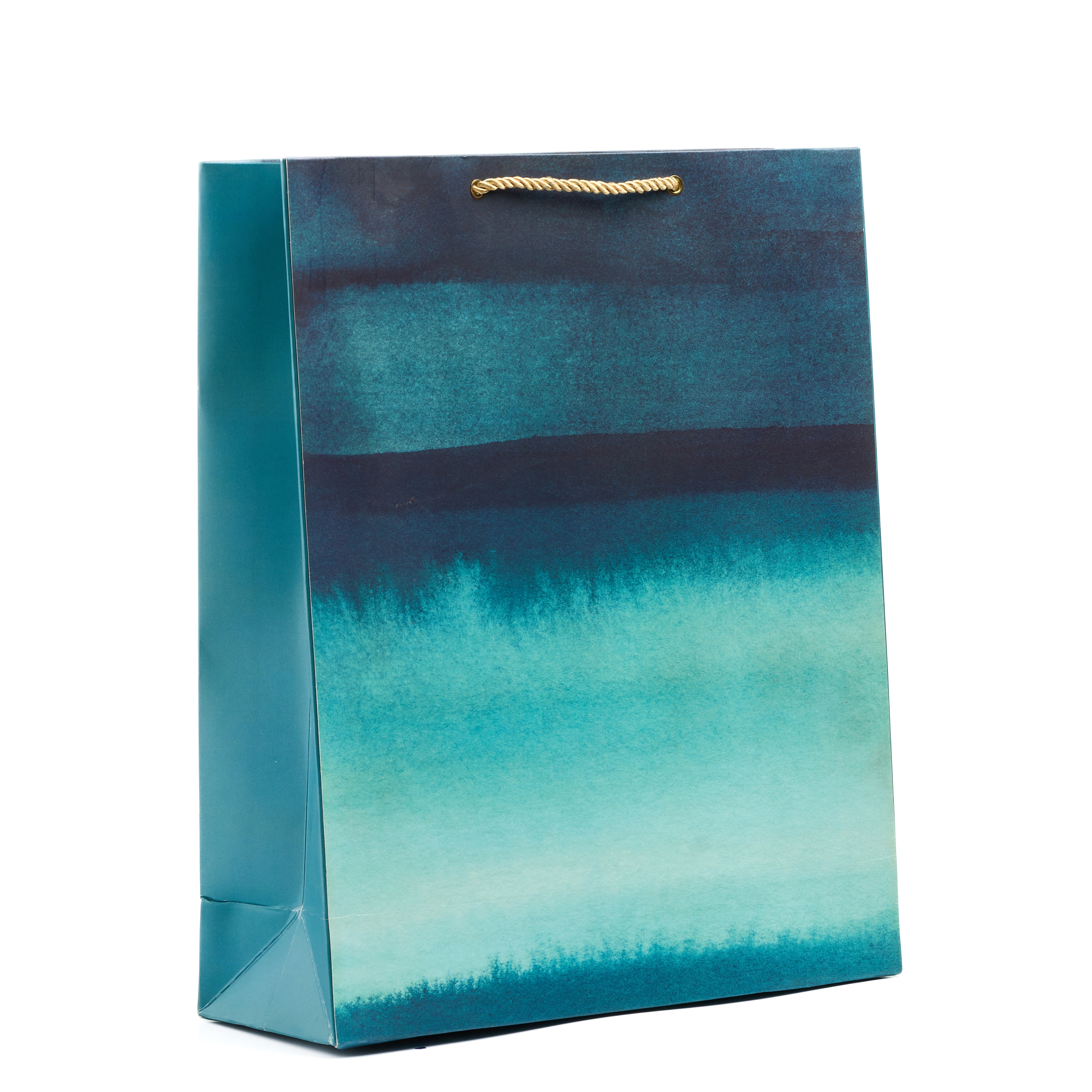 Teal watercolor shirt gift bag with ombré blue brushstrokes and matching side panels, perfect for artistic luxury gifting.