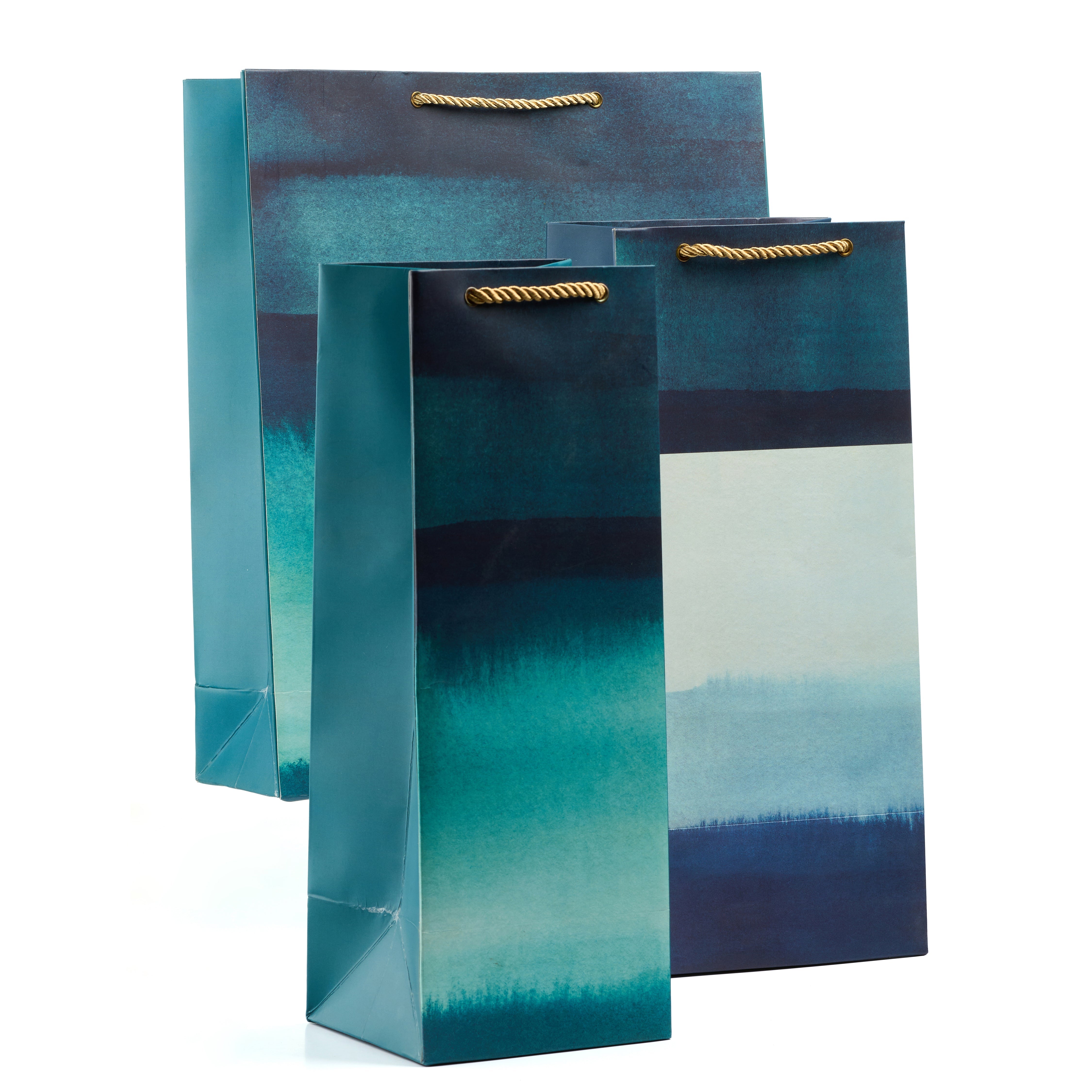 Grande gift bag set in rich teal watercolor style with shirt, medium, small, and wine bags—ideal for refined, art-inspired gifting.

