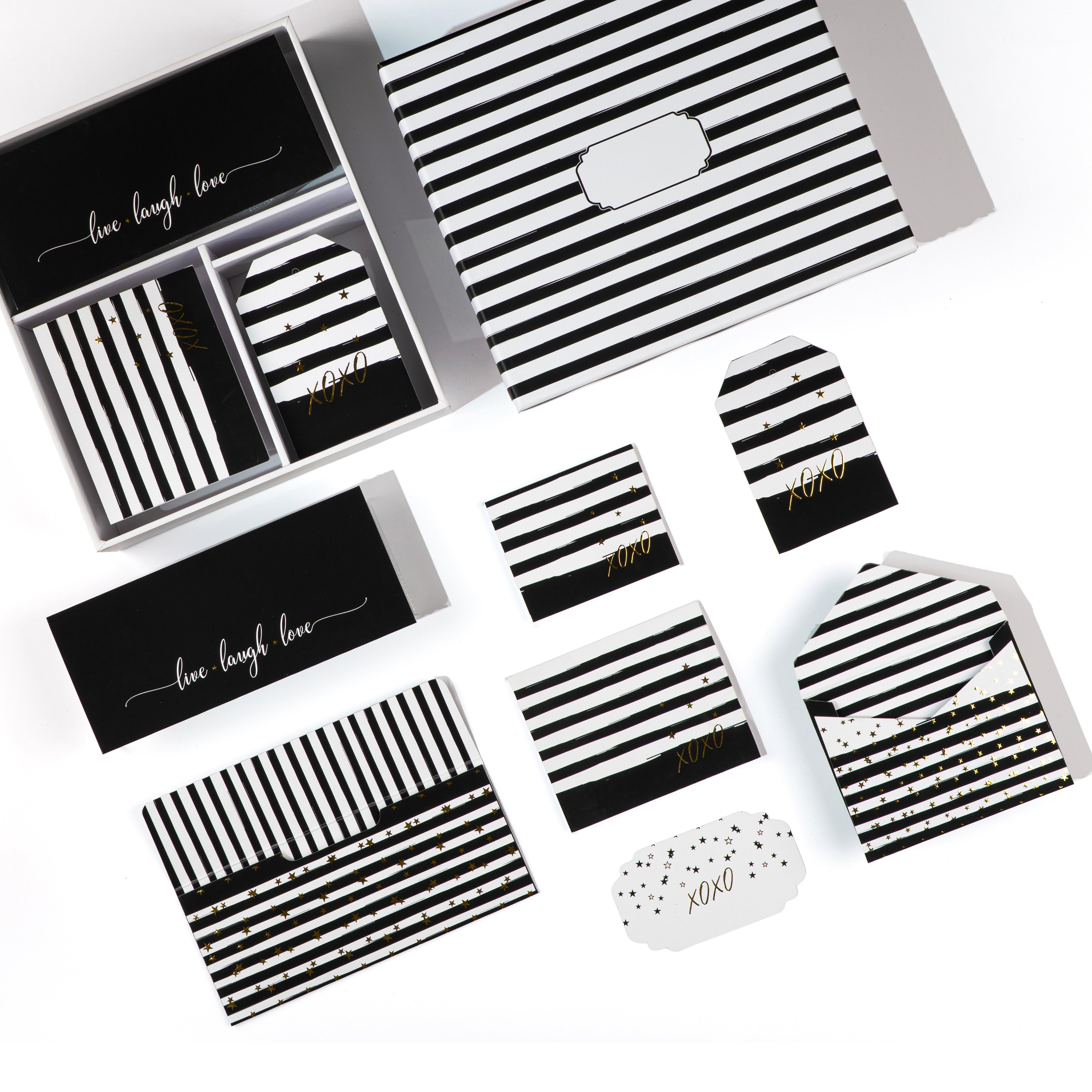 Black-and-white striped stationery set featuring “XOXO” accents and gold‑foil stars.