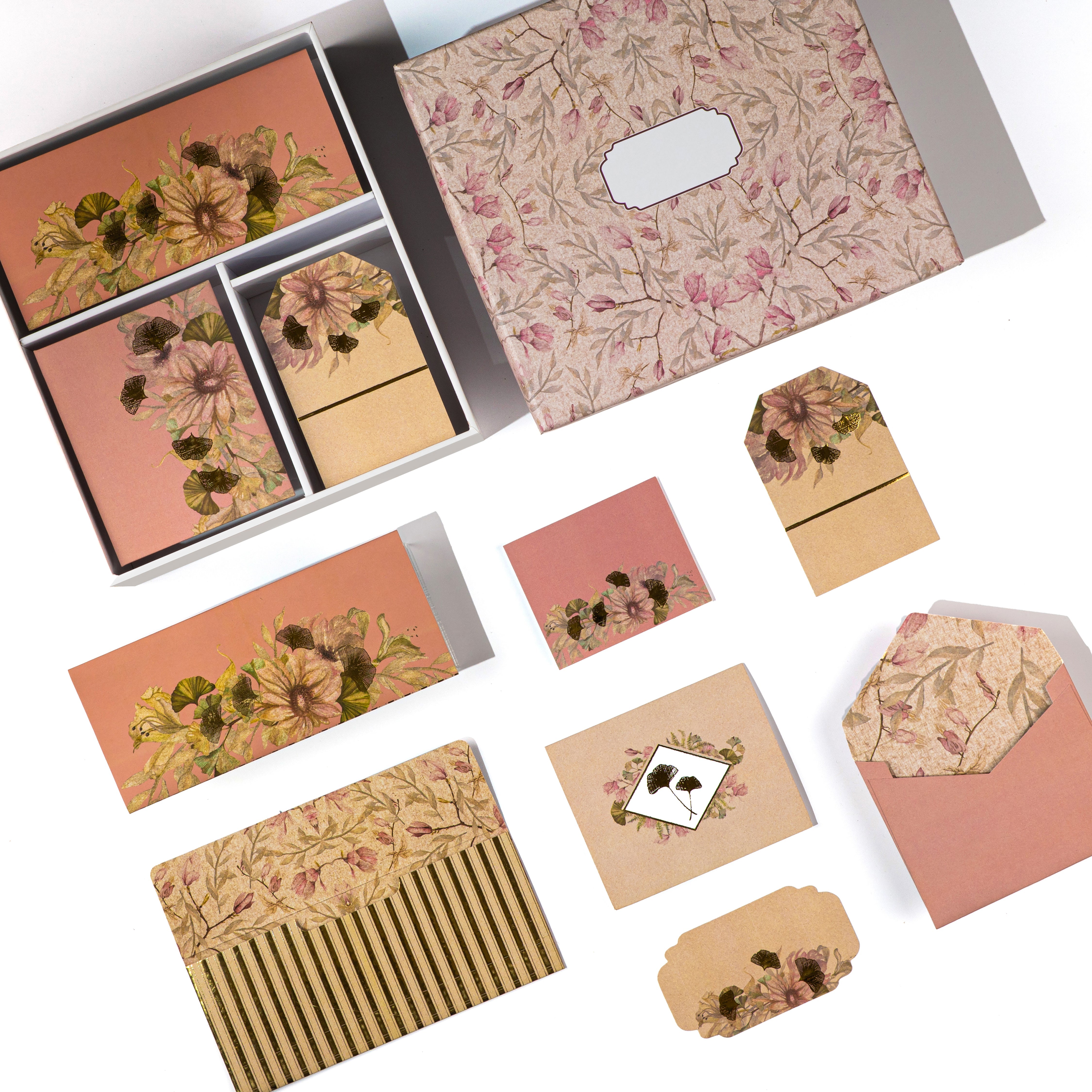 Soft pink stationery box with gold-accented floral designs and matching cards and tags.