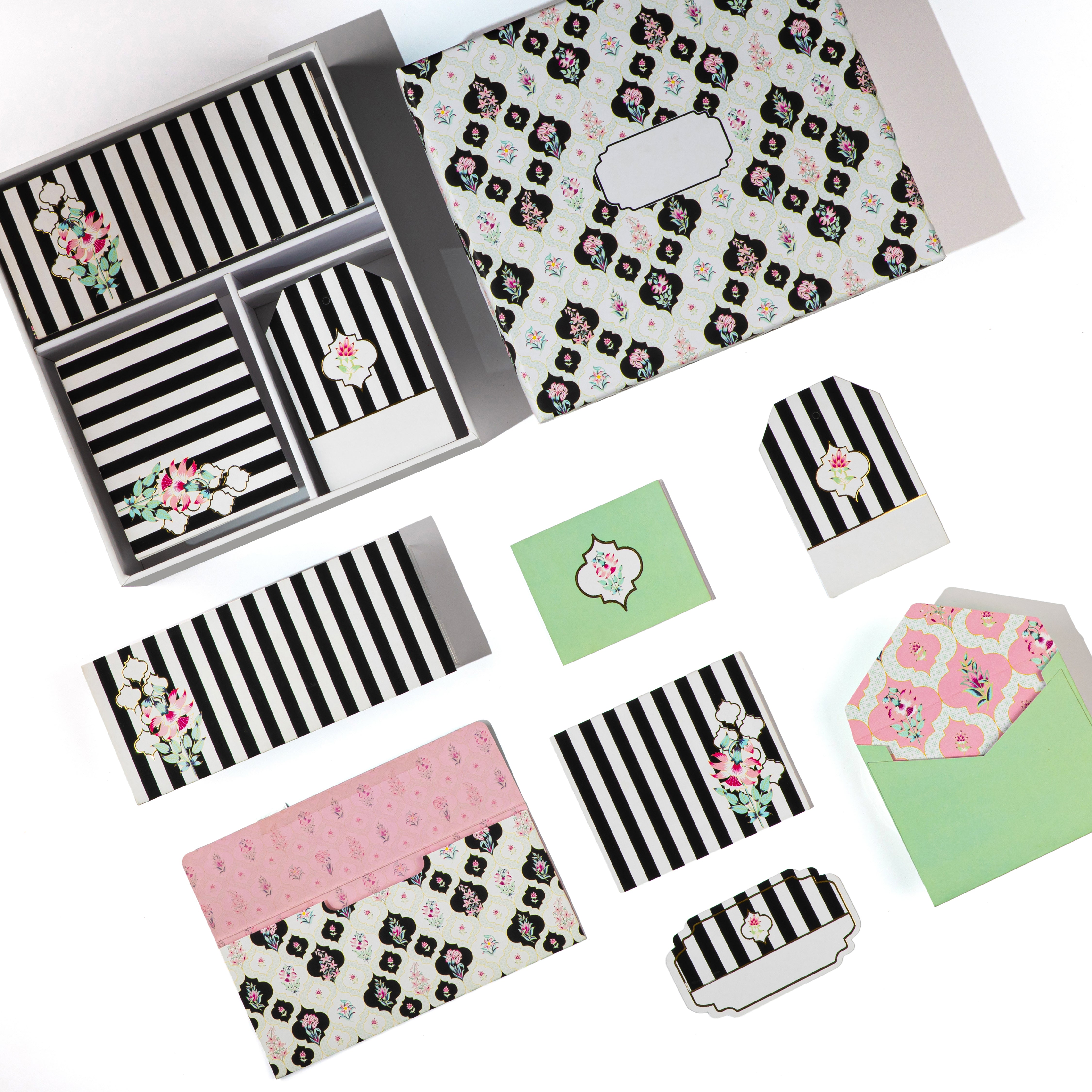 Black-and-white medallion stationery set with floral accents and coordinating envelope liners.