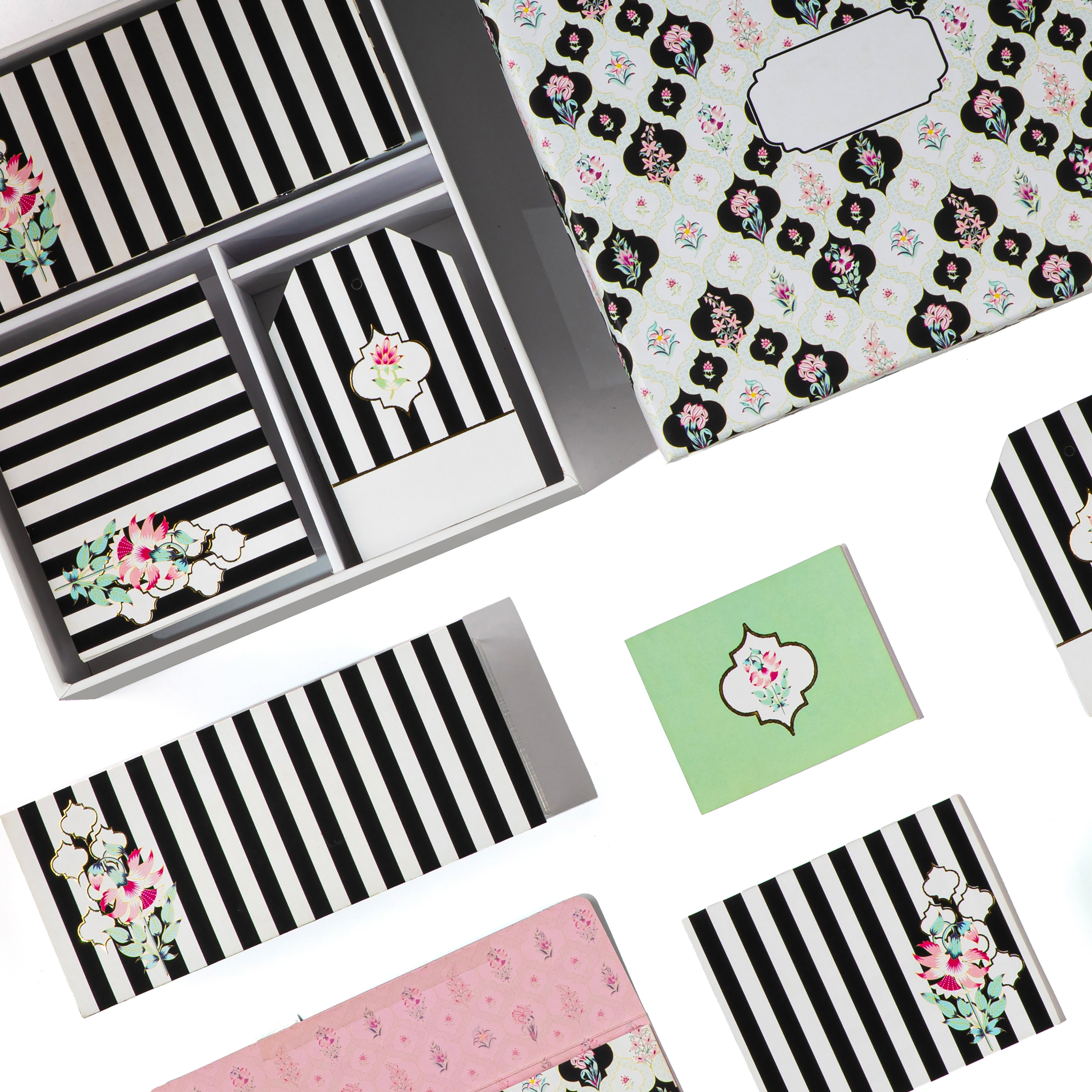 Black-and-white medallion stationery set with floral accents and coordinating envelope liners.