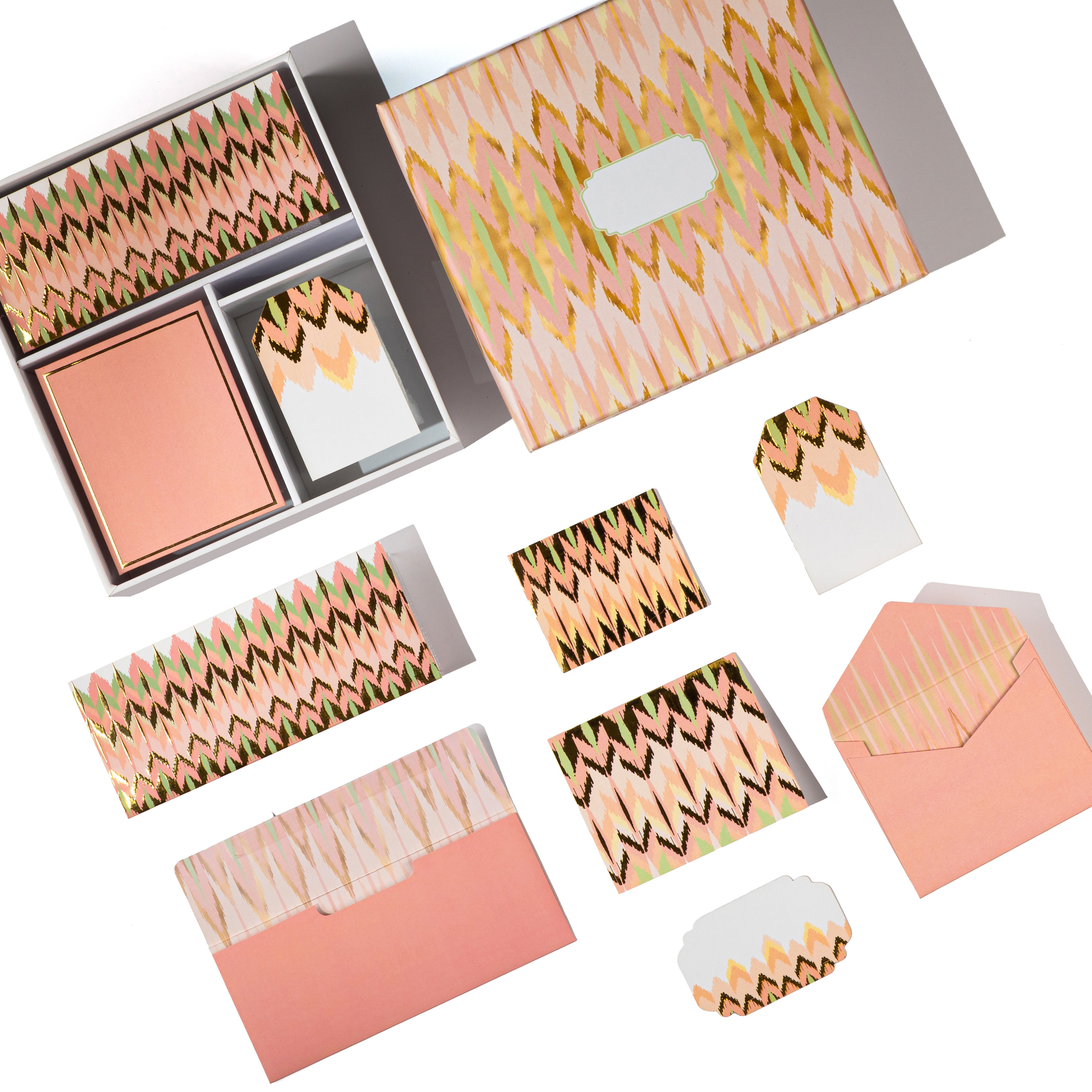 Peach and gold ikat-patterned boxed stationery set with matching cards and tags.