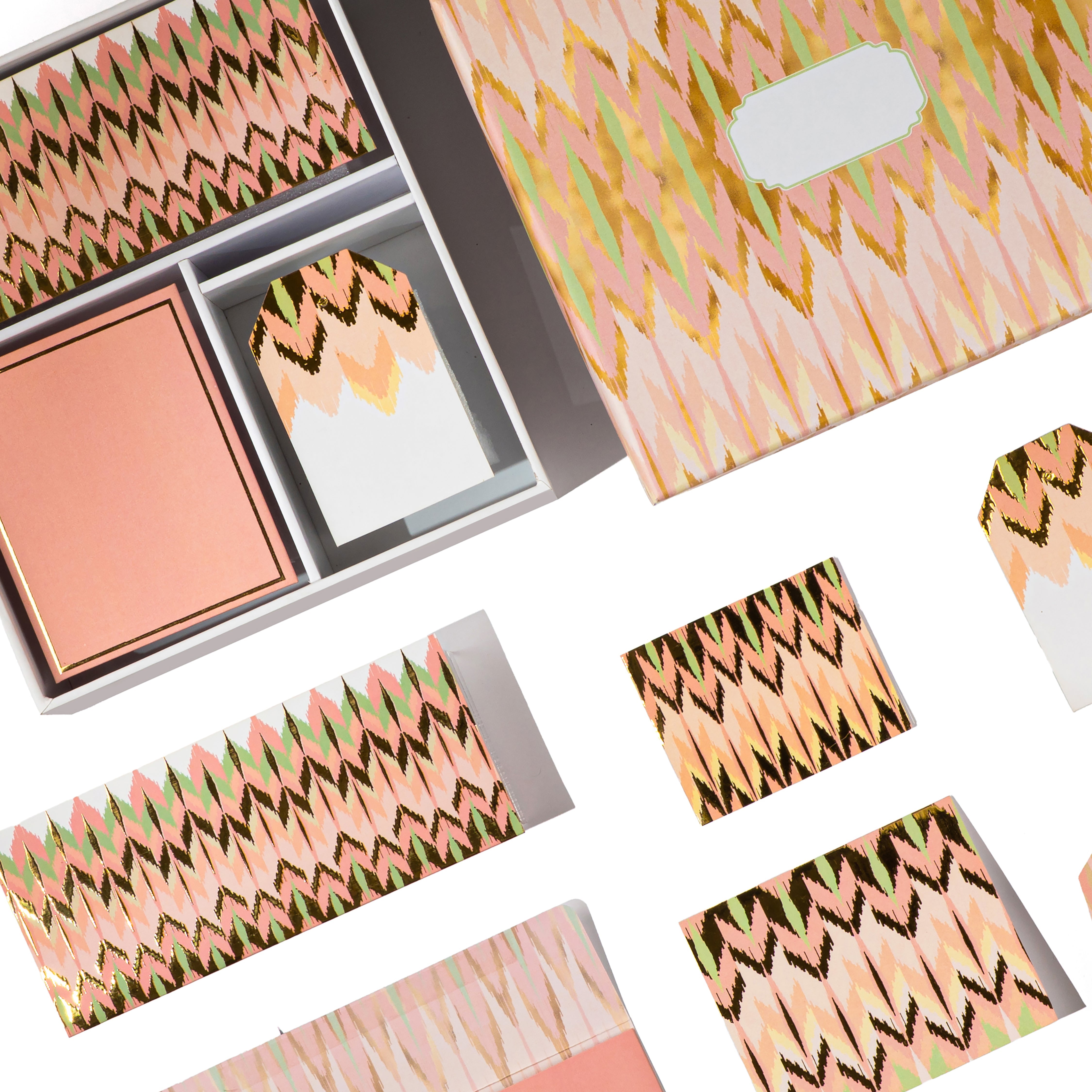 Peach and gold ikat-patterned boxed stationery set with matching cards and tags.