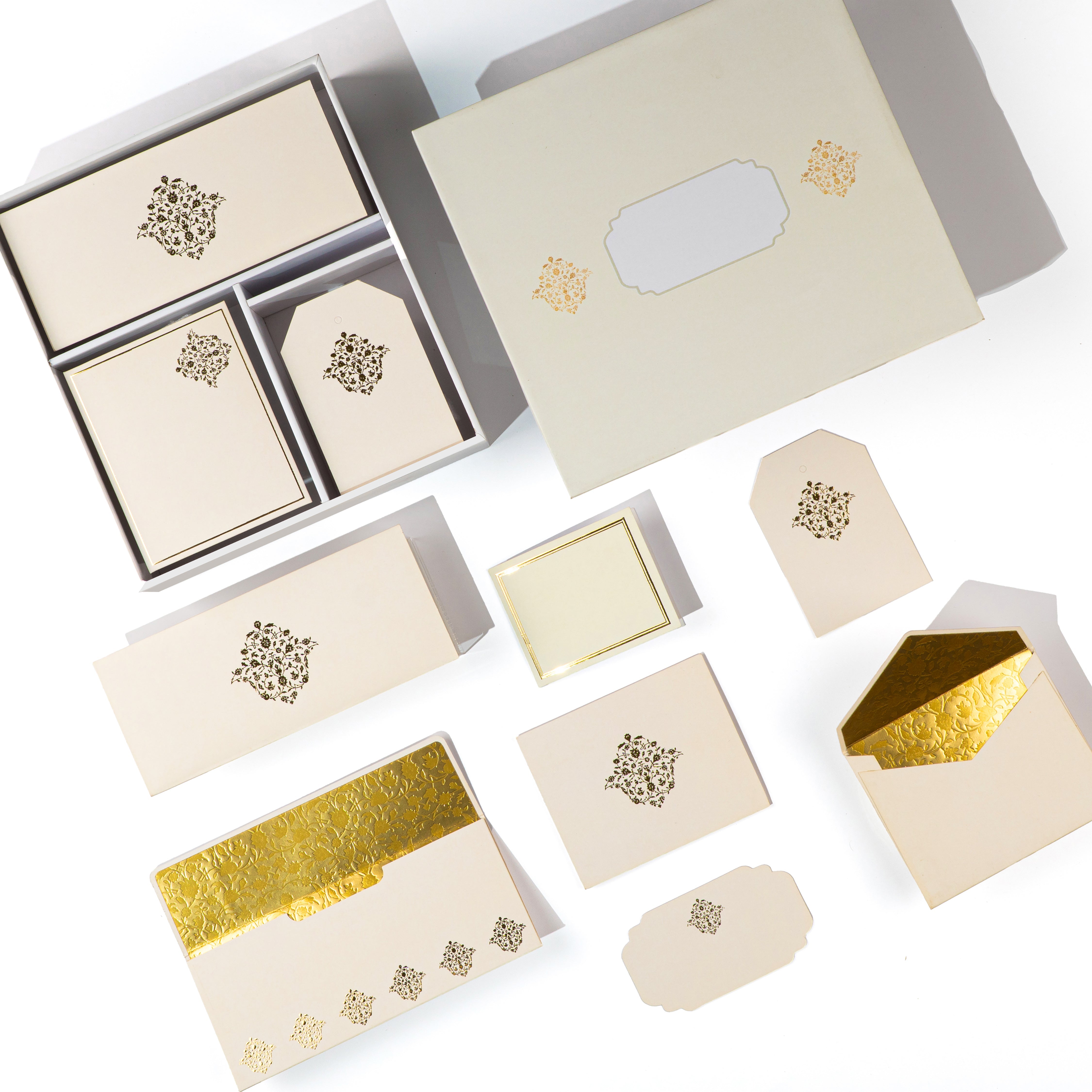 Minimal beige and gold foil stationery set with intricate Mughal-inspired motifs, perfect for gifting and events.