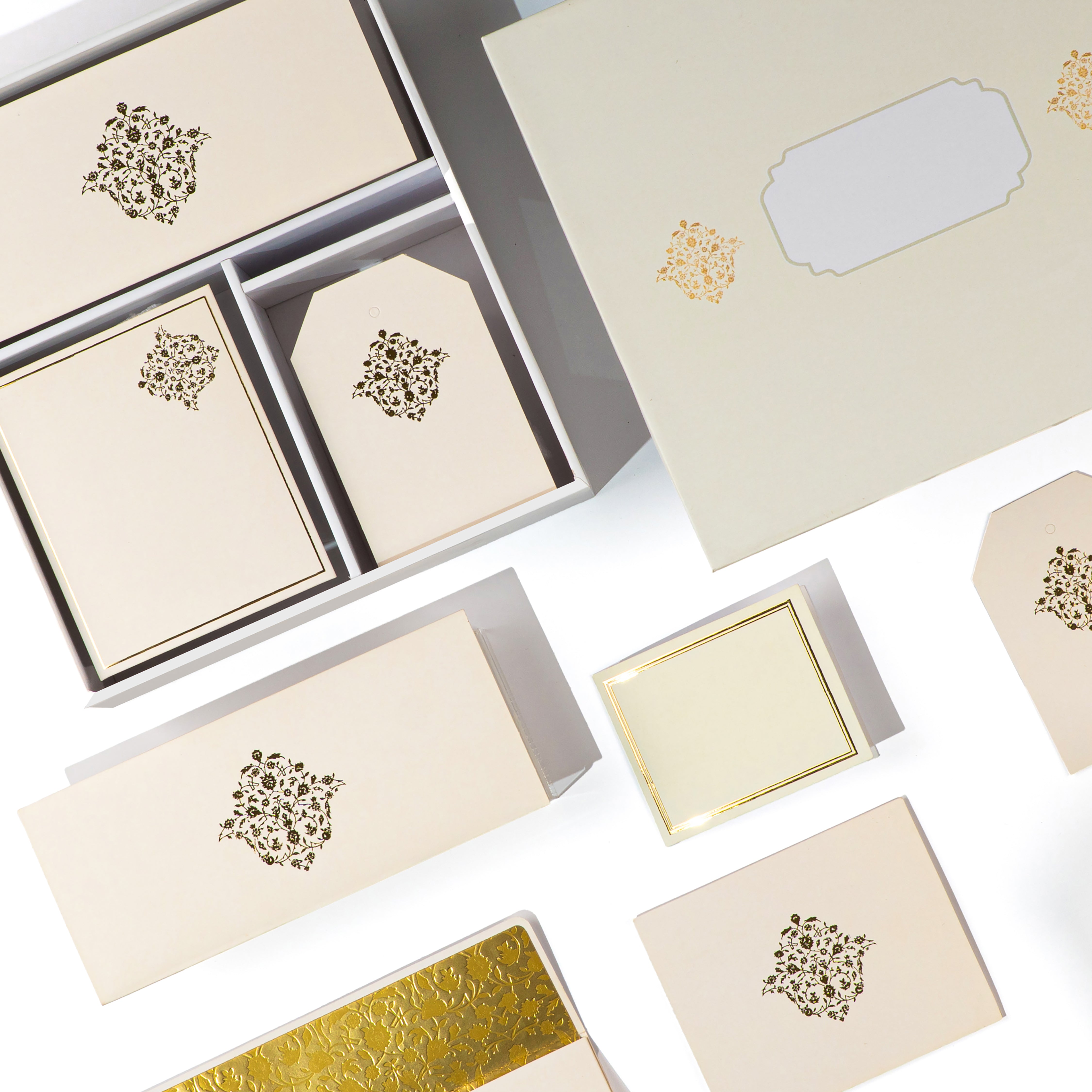 Minimal beige and gold foil stationery set with intricate Mughal-inspired motifs, perfect for gifting and events.