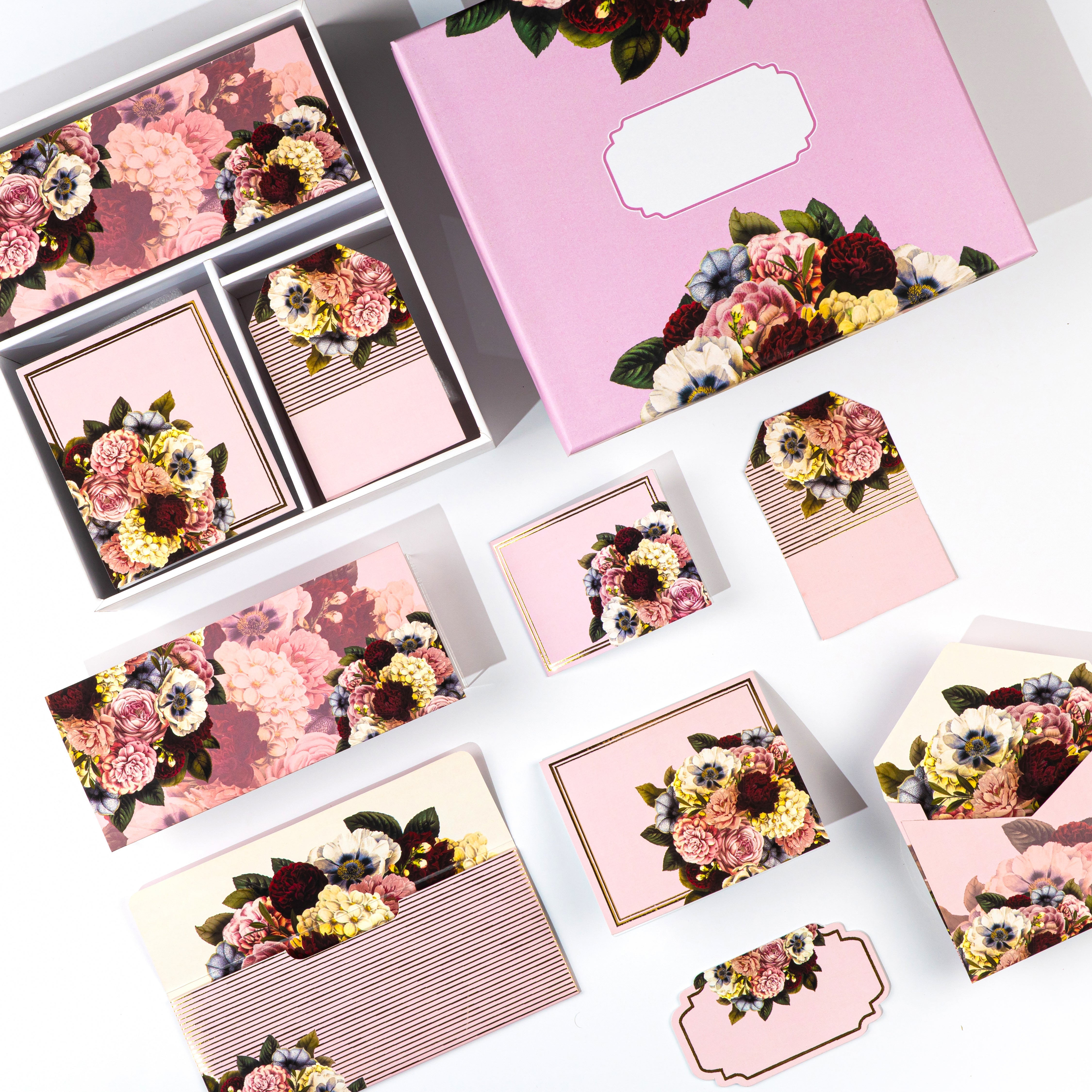 Pink floral stationery gift box with envelopes, tags, folded cards, and stickers.

