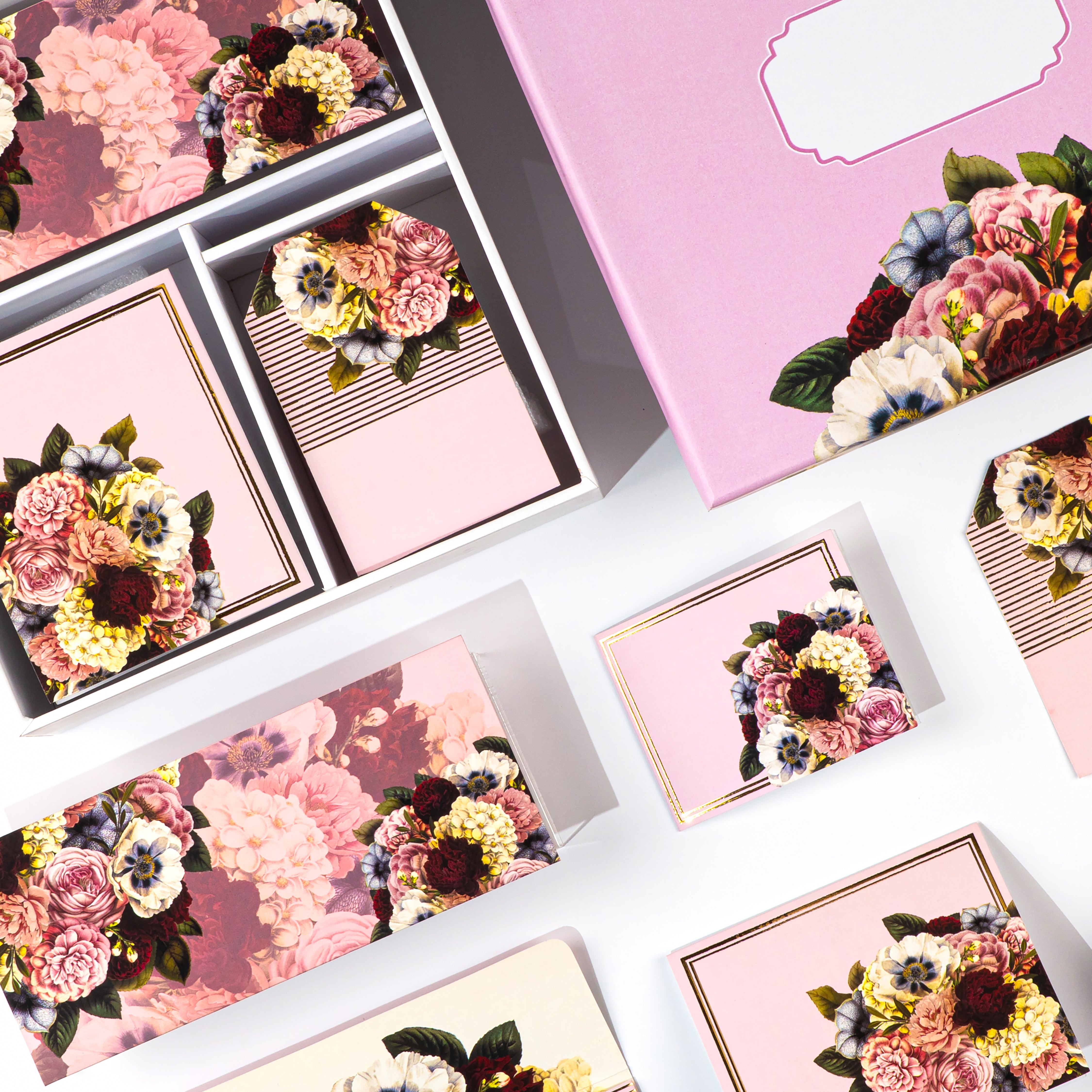 Pink floral stationery gift box with envelopes, tags, folded cards, and stickers.

