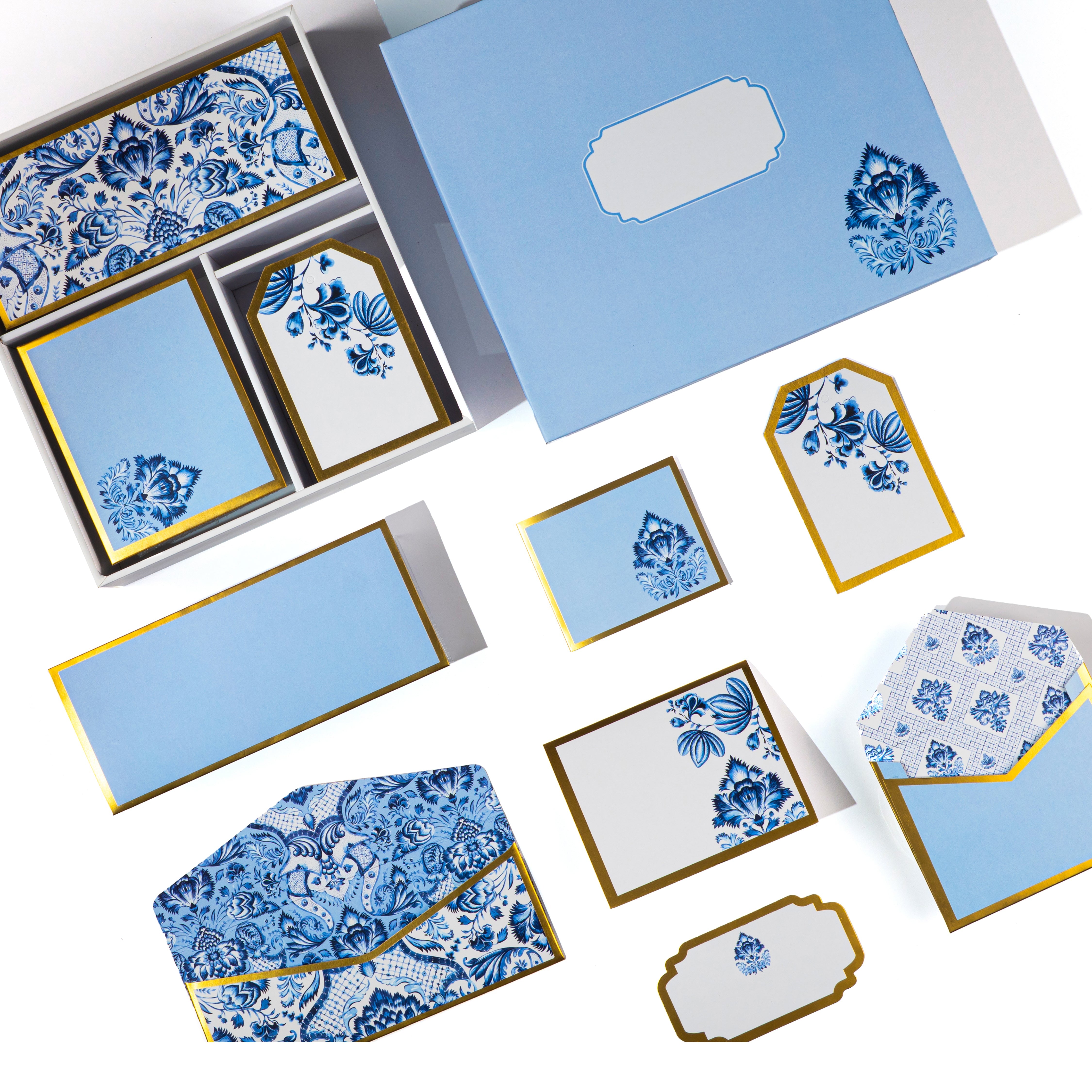 Blue and white Mughal floral stationery set with gold detailing, includes matching cards, tags, and envelopes.