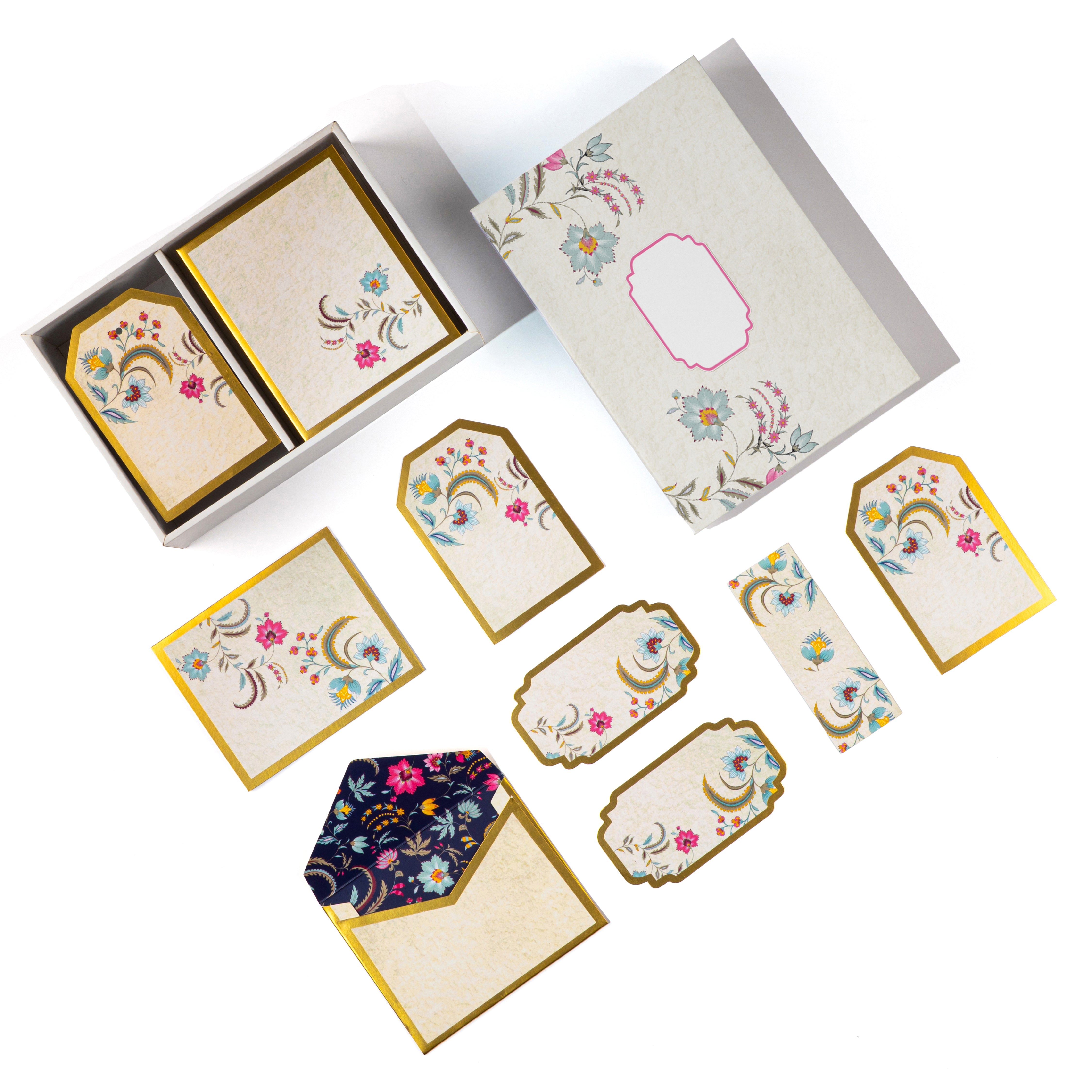 Floral gold-bordered stationery set with tags, notes, and envelope.


