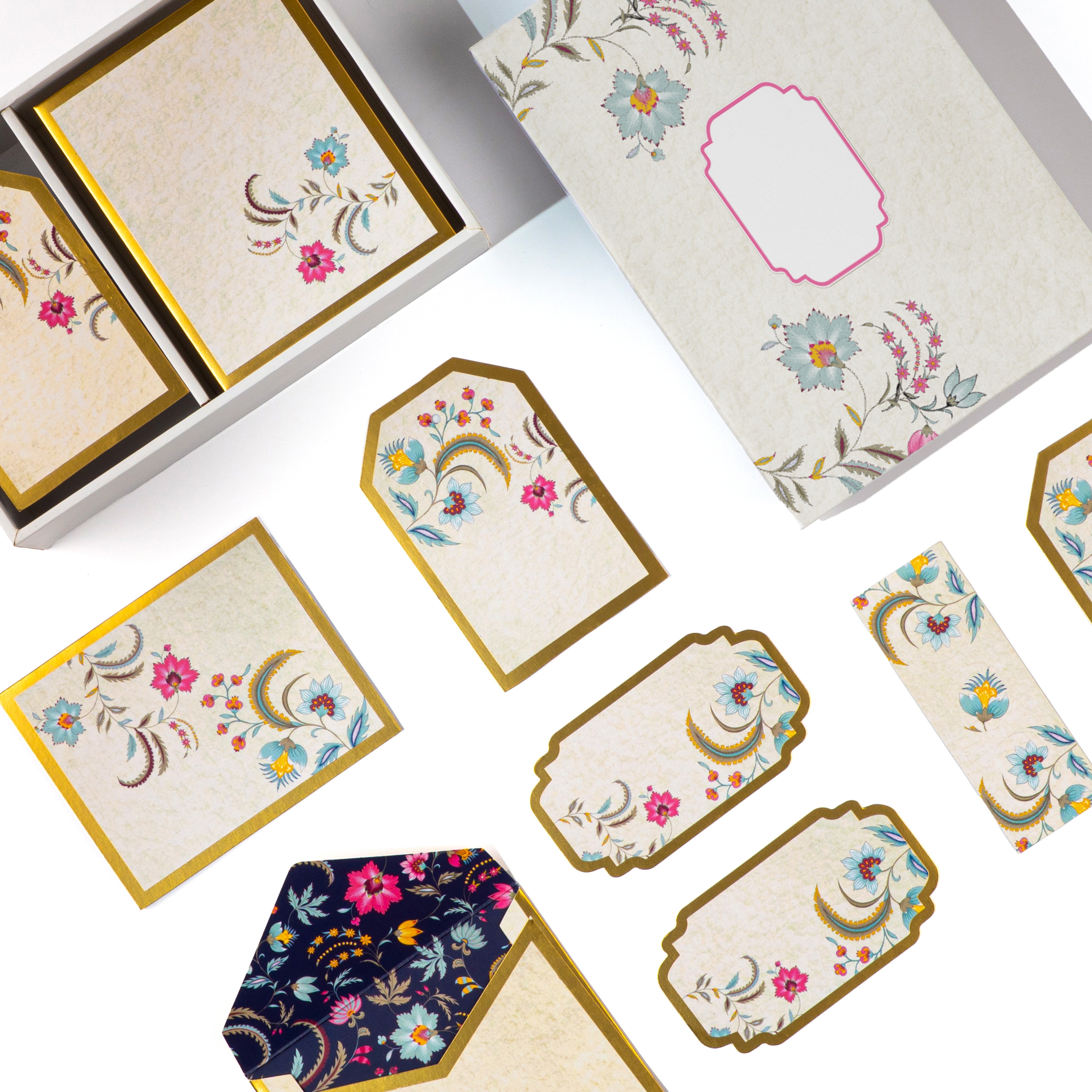Floral gold-bordered stationery set with tags, notes, and envelope.

