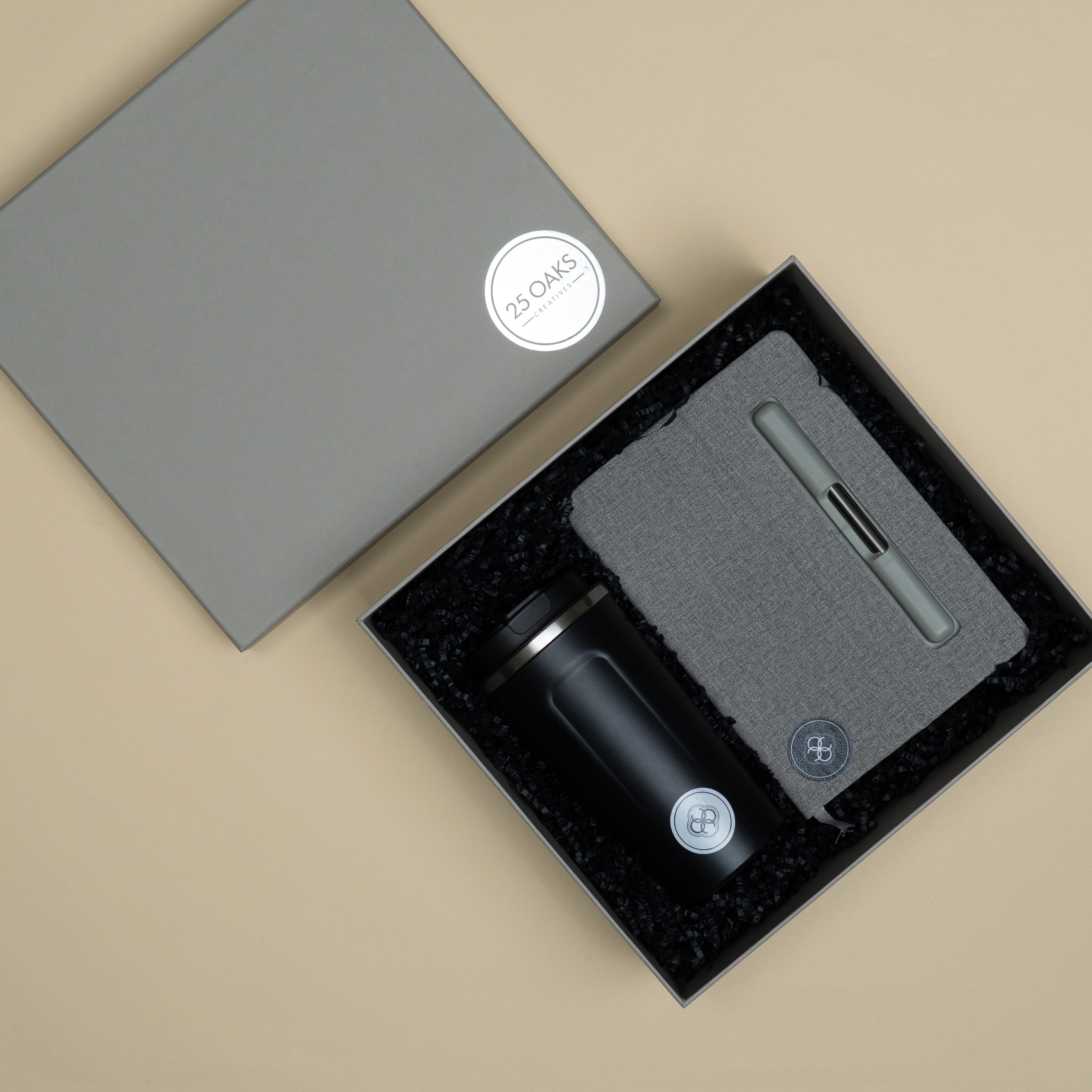 The Commute corporate gifting set with a premium diary, metallic pen and travel tumbler arranged in a customised cardboard presentation box.
