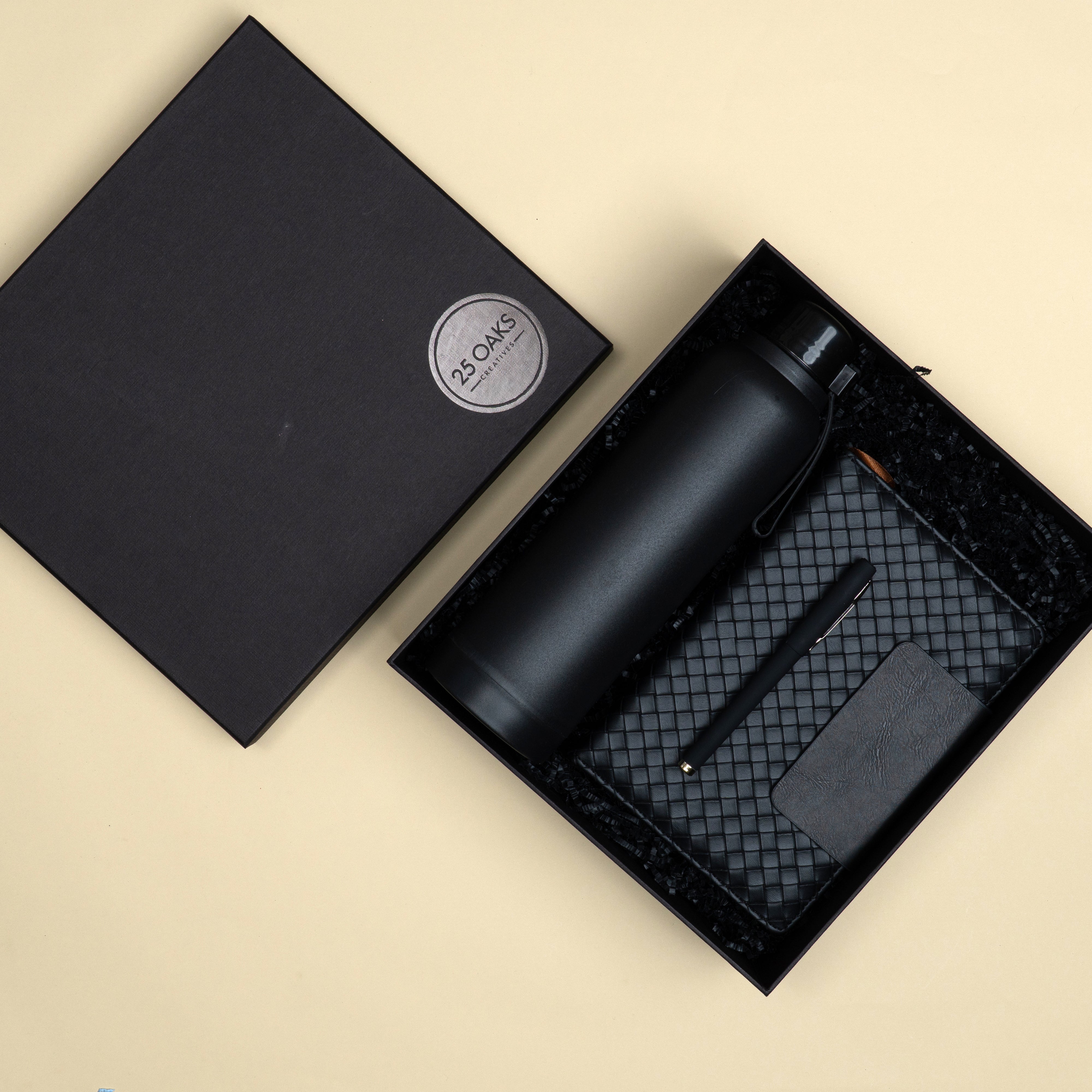The Executive Black corporate gifting set with a black bottle, premium diary and metallic pen arranged in a customized presentation box.