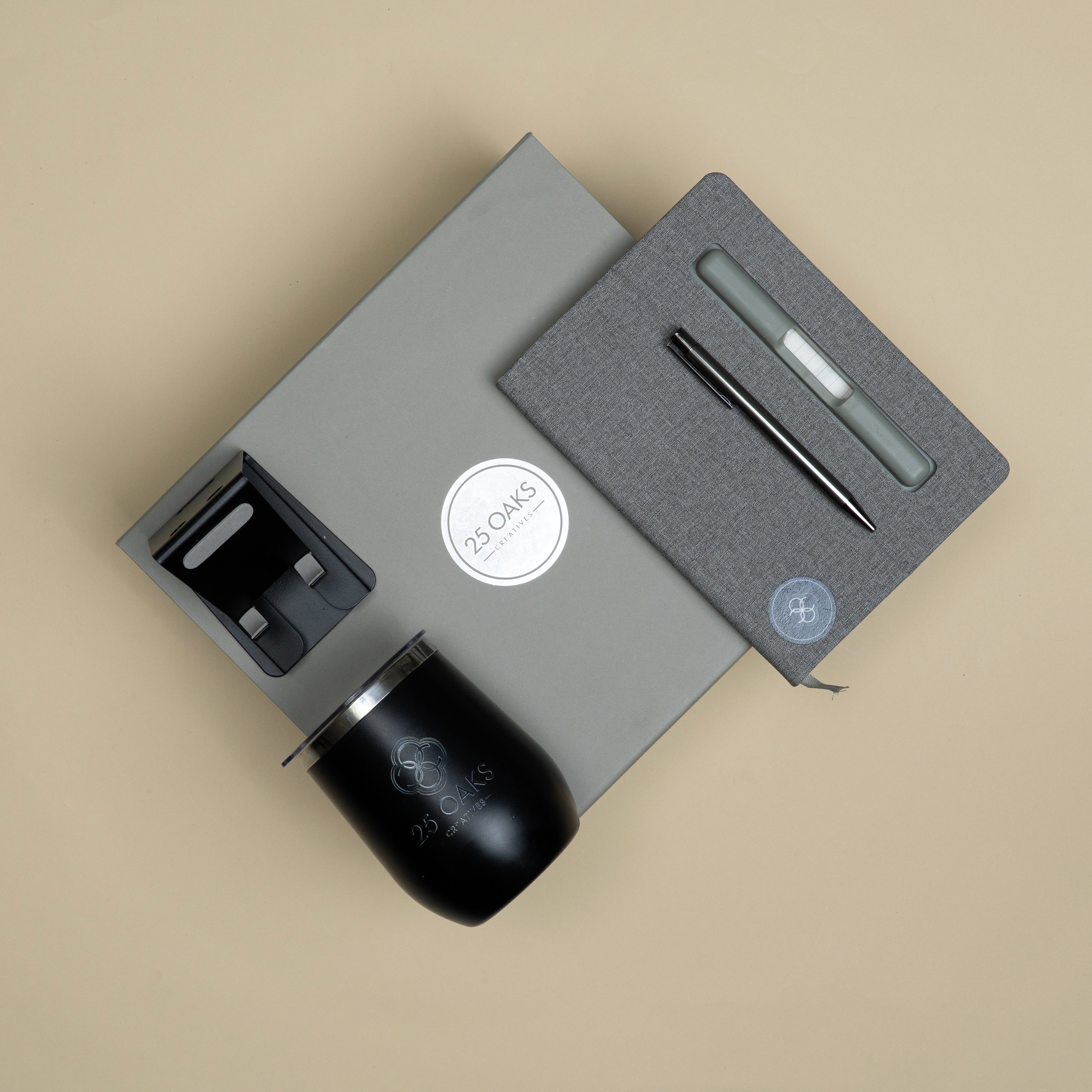 Premium customized corporate gifting set featuring a grey diary, black pen, card holder pen stand and double-wall insulated mug.
