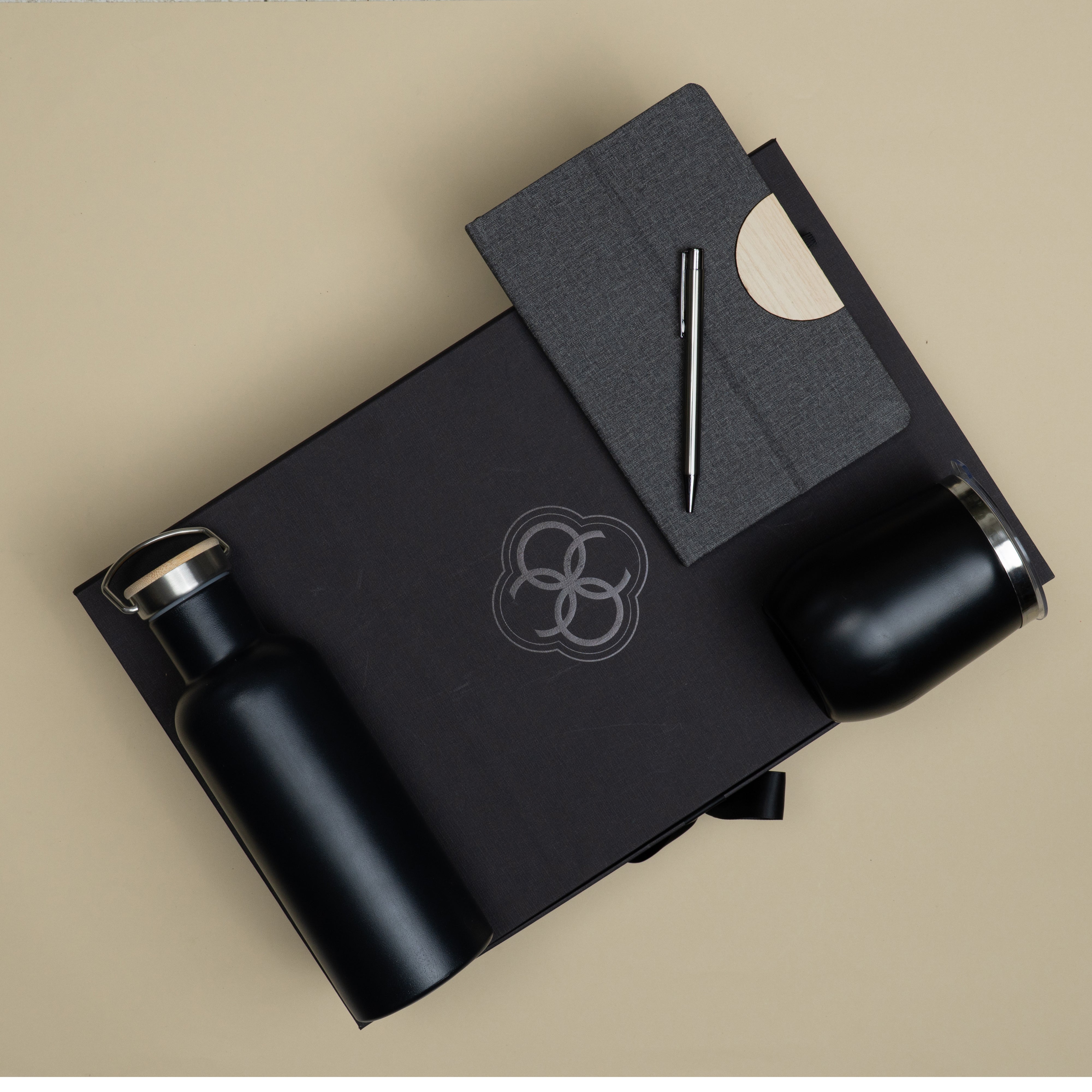 Premium customized corporate gifting set featuring vacuum bottle, travel mug, metallic pen and phone stand diary