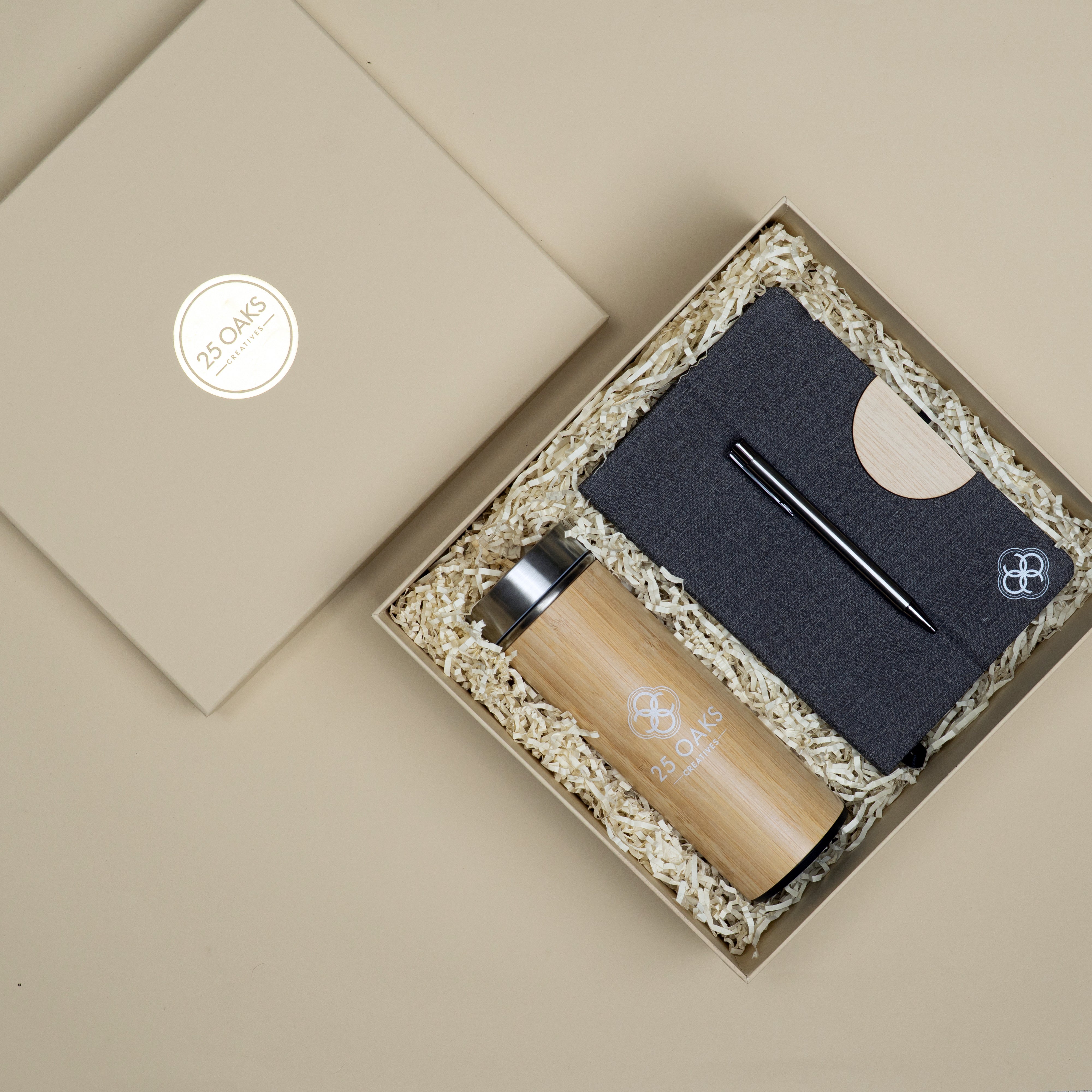 The Classic Desk corporate gift set with bamboo bottle, premium diary with phone holder stand and black metallic pen in a cardboard gift box.