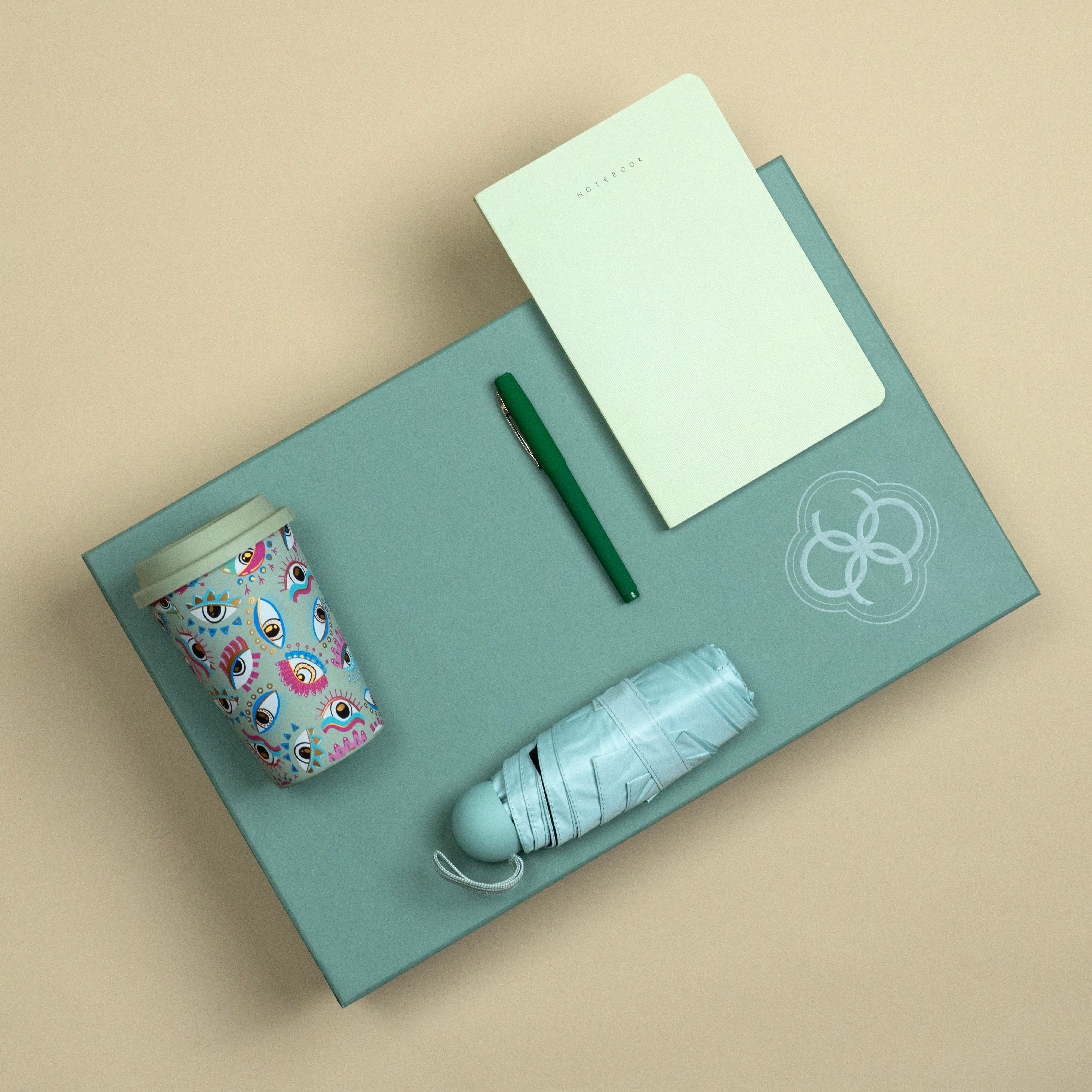 The On The Go sage corporate gift set with printed tumbler, A5 notebook, matte green pen and compact umbrella.